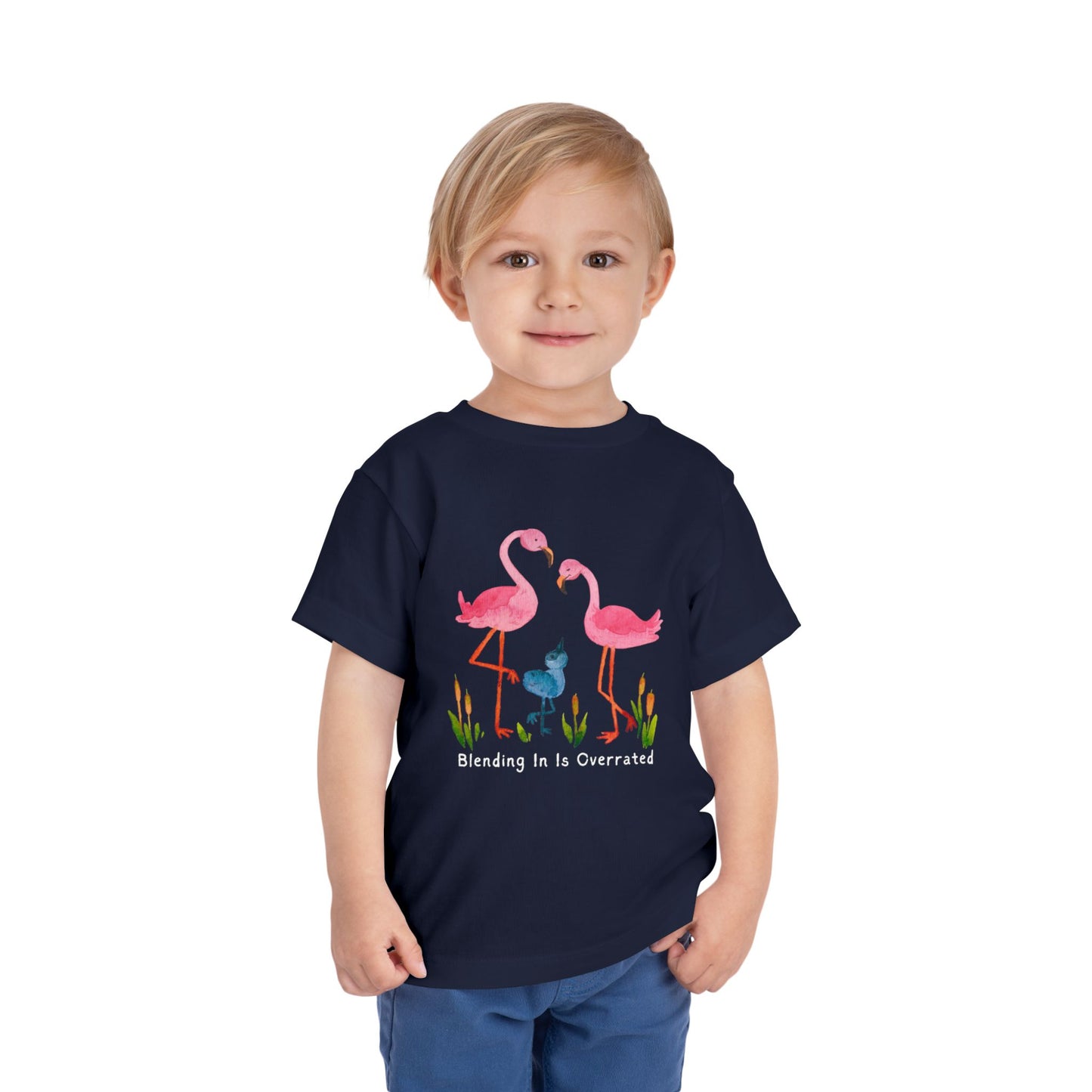Child wearing a navy blue toddler t-shirt with pink flamingo family and text 'Blending In Is Overrated'