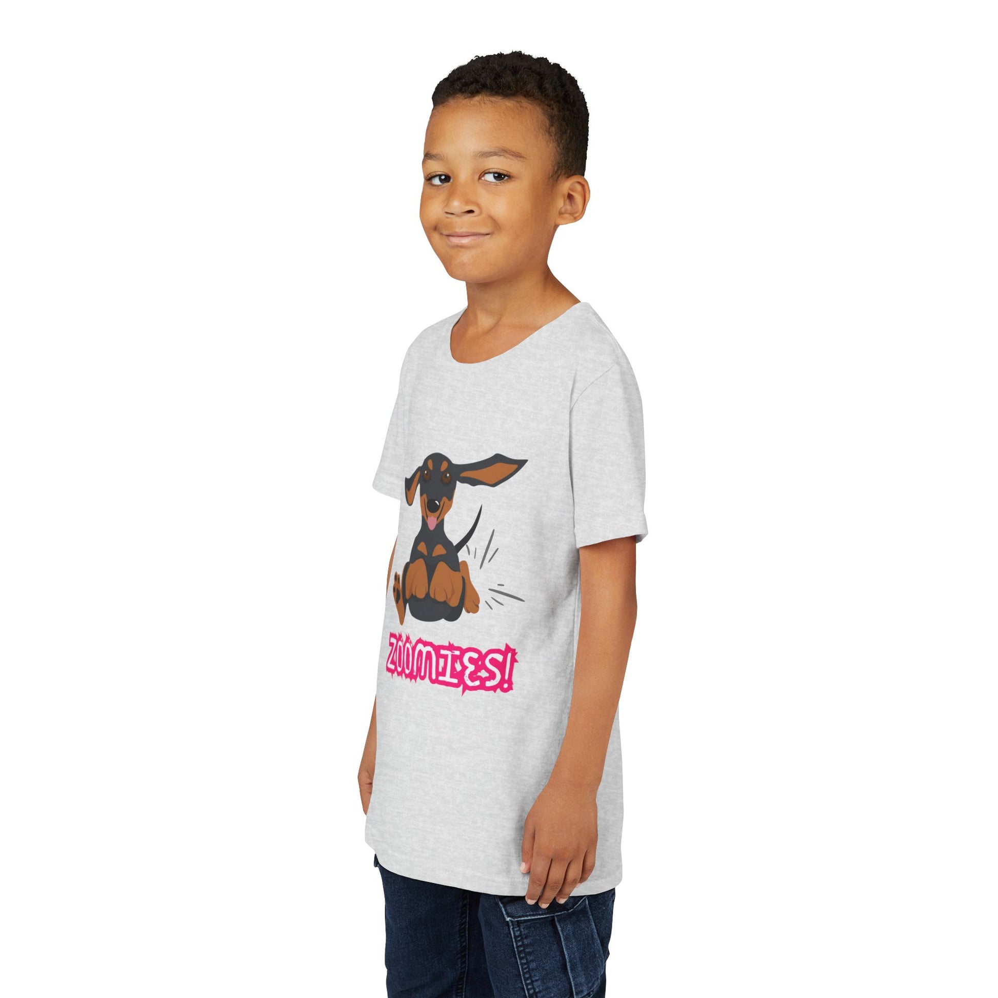 Boy wearing a light gray t-shirt with a running dachshund and 'Zoomies!' text 