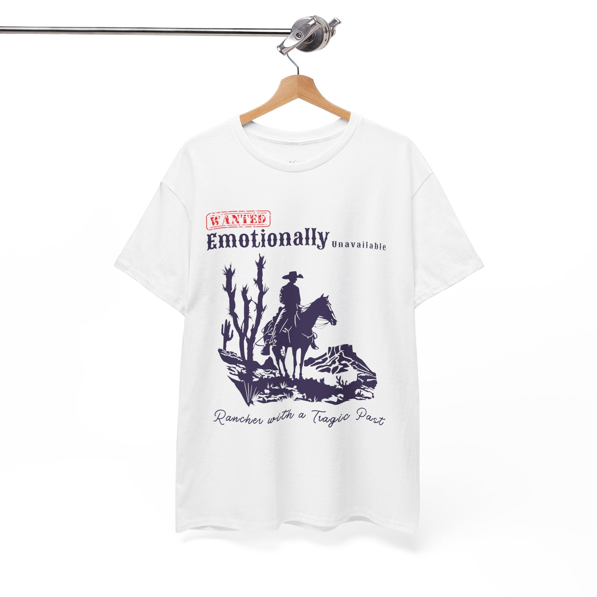 White t-shirt with a horse riding cowboy in a desert setting and text 'WANTED Emotionally Unavailable Rancher With A Tragic Past'