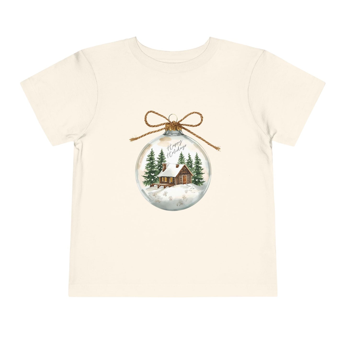 Beige/natural toddler t-shirt with a Christmas-themed ornament graphic featuring a cabin and trees 