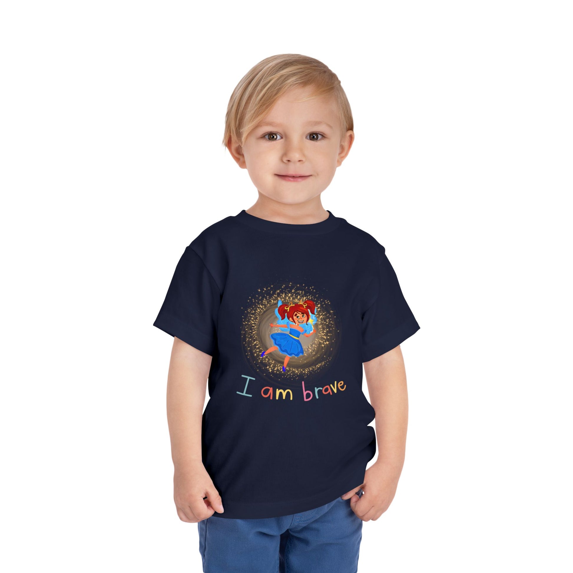 Child wearing a toddler t-shirt with a fairy in spiral of sparkling light and text 'I Am Brave' 