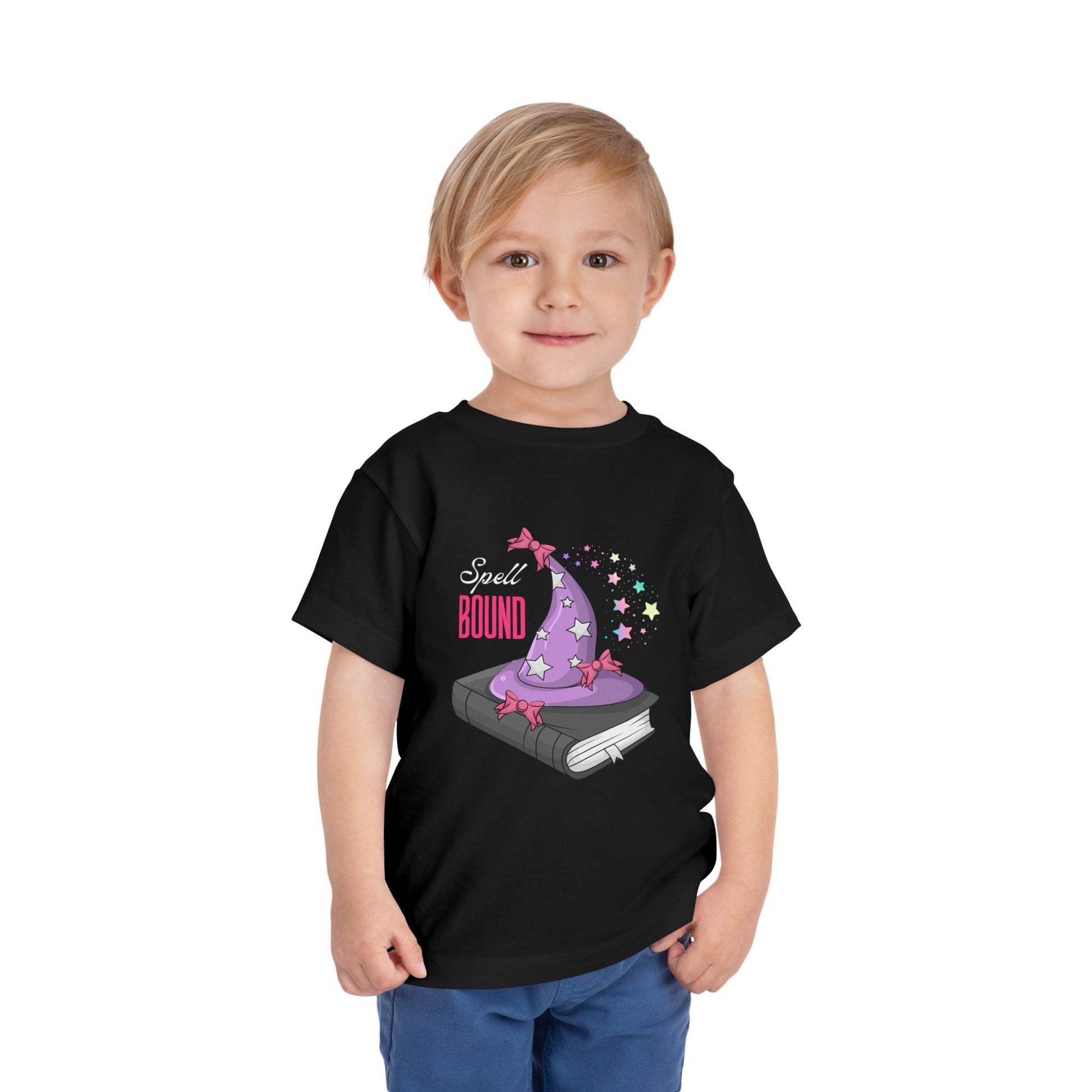 Child wearing a black toddler t-shirt with a wizard hat atop a book and 'Spell Bound' text on a white background