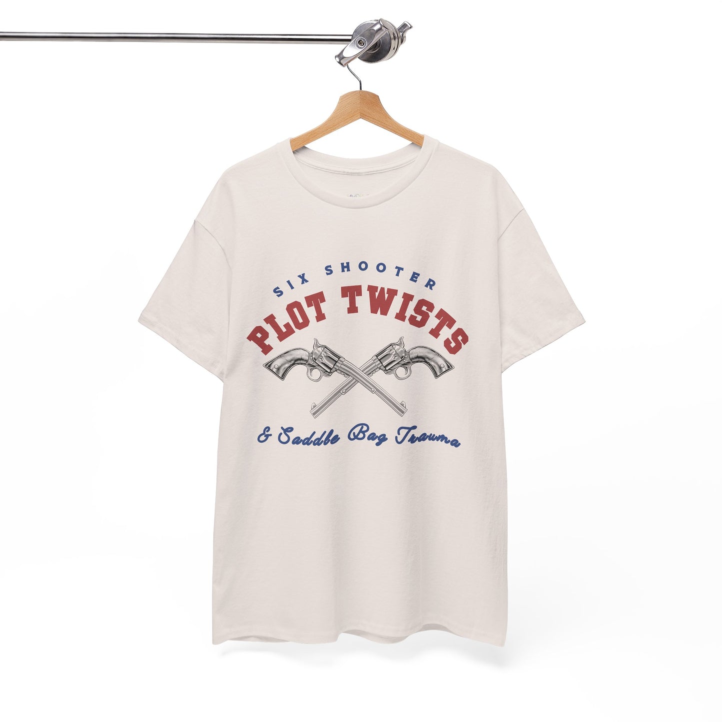 Tan t-shirt with two pistols criss-crossed in the center and text 'Six Shooter Plot Twists & Saddle Bag Trauma'