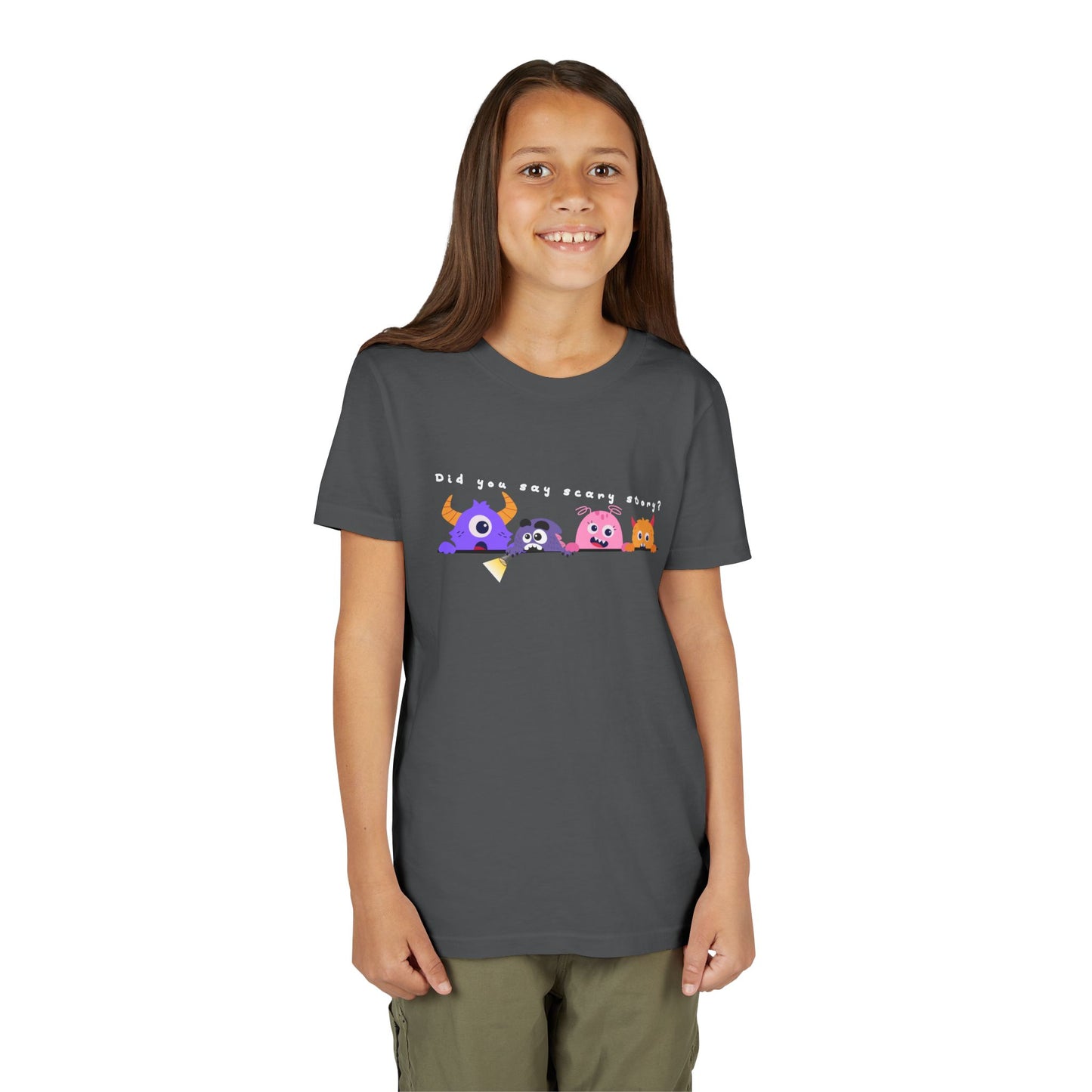 Girl wearing a gray t-shirt with a row of worried colorful cartoon monsters peaking over the edge of a line and text 'Did You Say Scary Story?' 