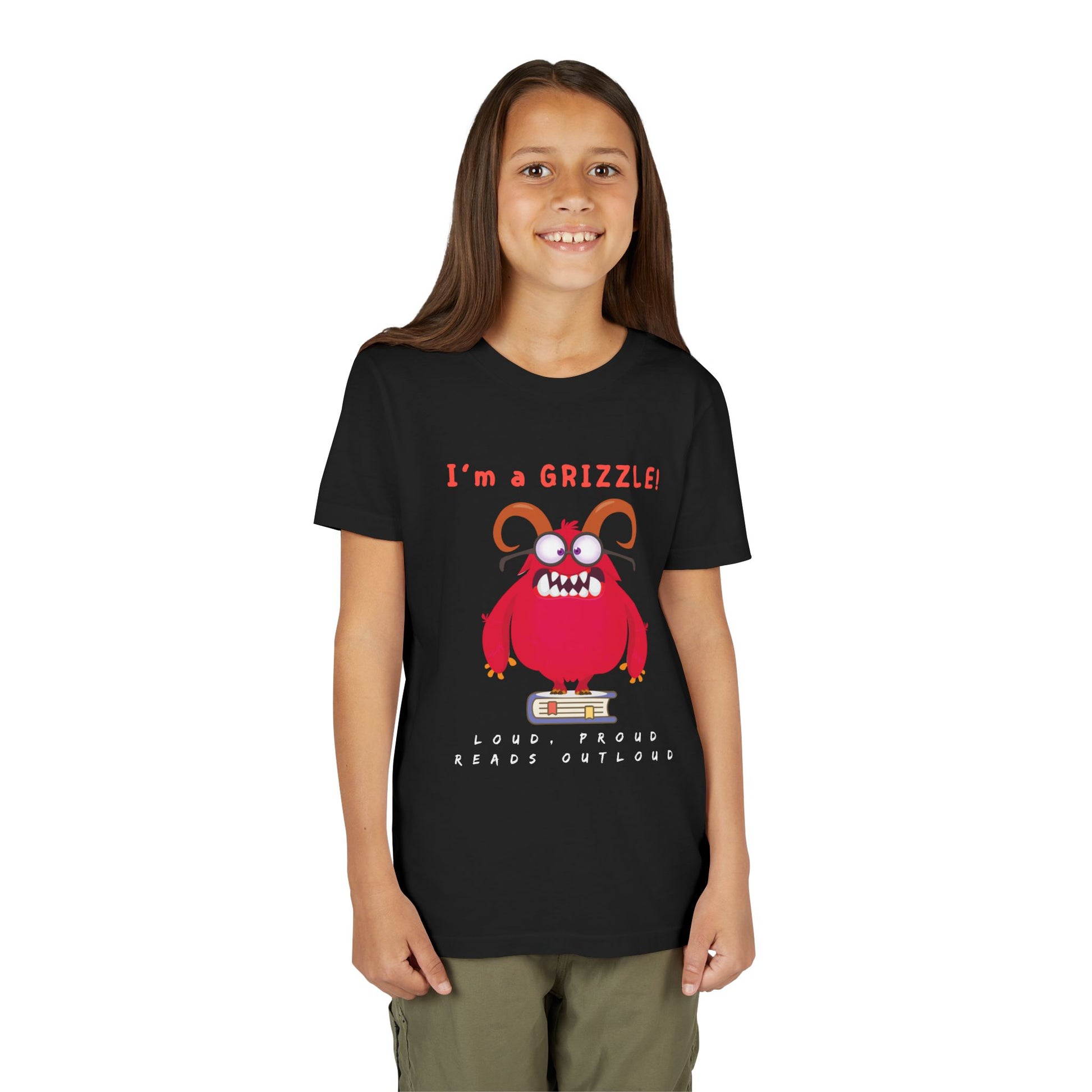 Girl wearing a black personality t-shirt with a red eye glass wearing monster standing on a book and announcing 'I'm a GRIZZLE!'