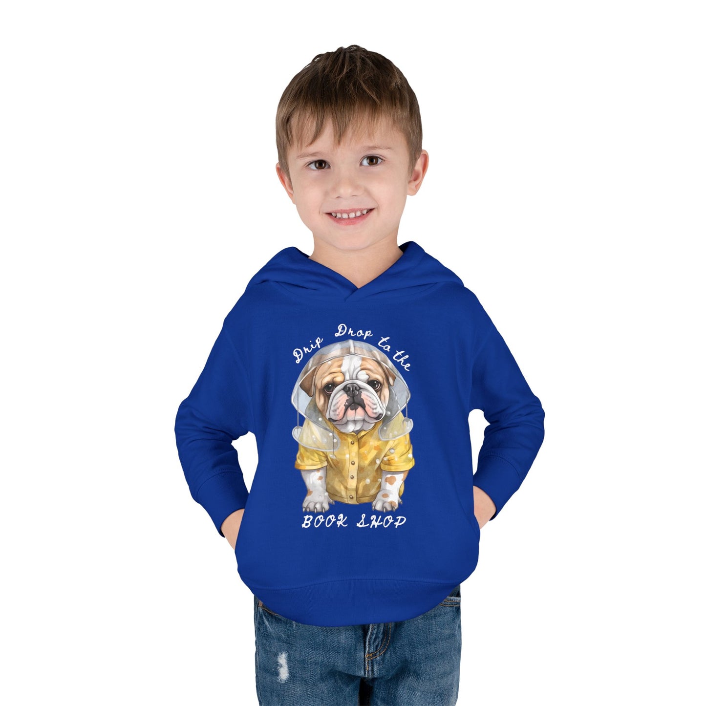 Boy wearing a blue toddler hoodie with a raincoat wearing bulldog and text 'Drip Drop to the Book Shop' on a white background