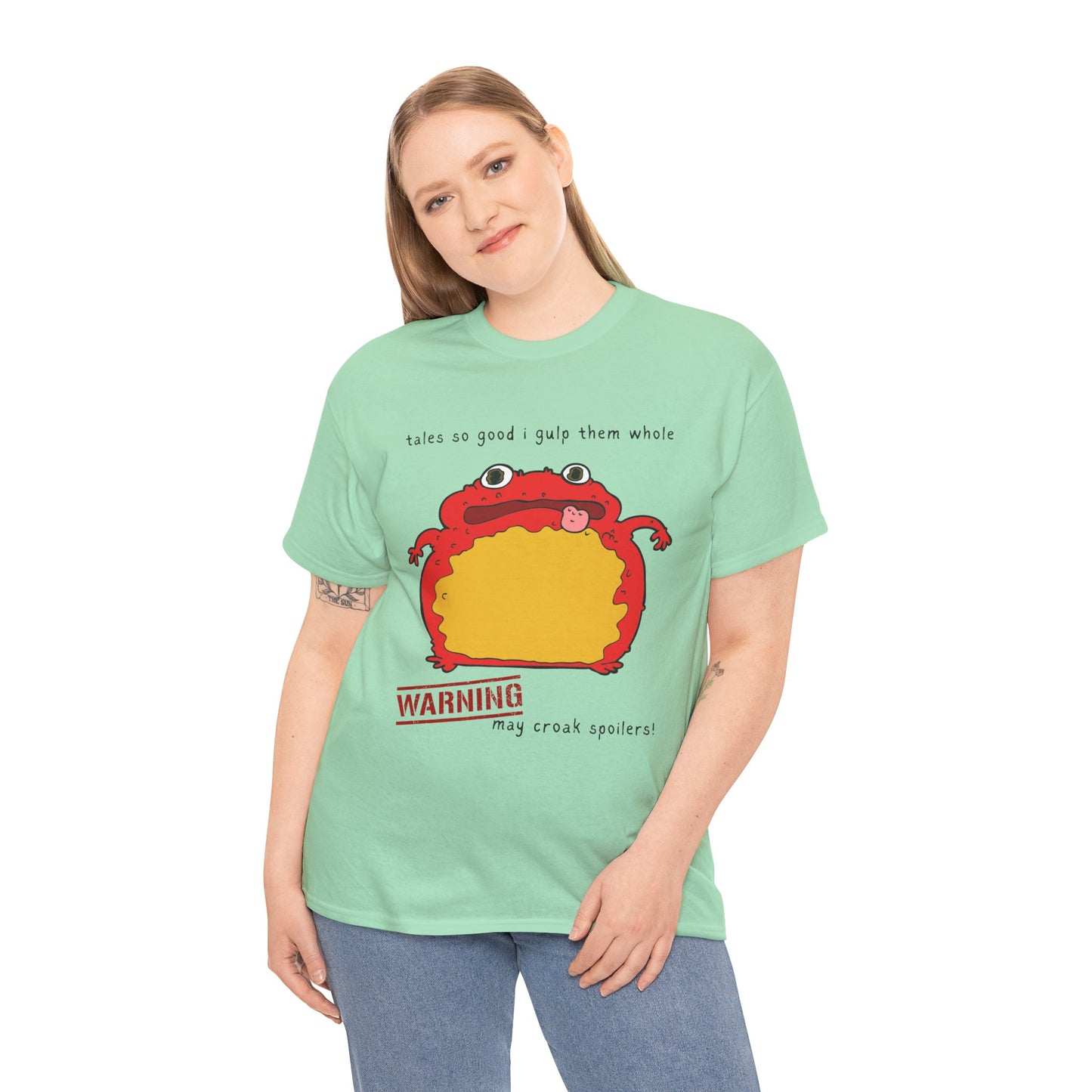 Woman wearing a light green t-shirt with a red toad and text 'tales so good I gulp them whole' and 'WARNING may croak spoilers'