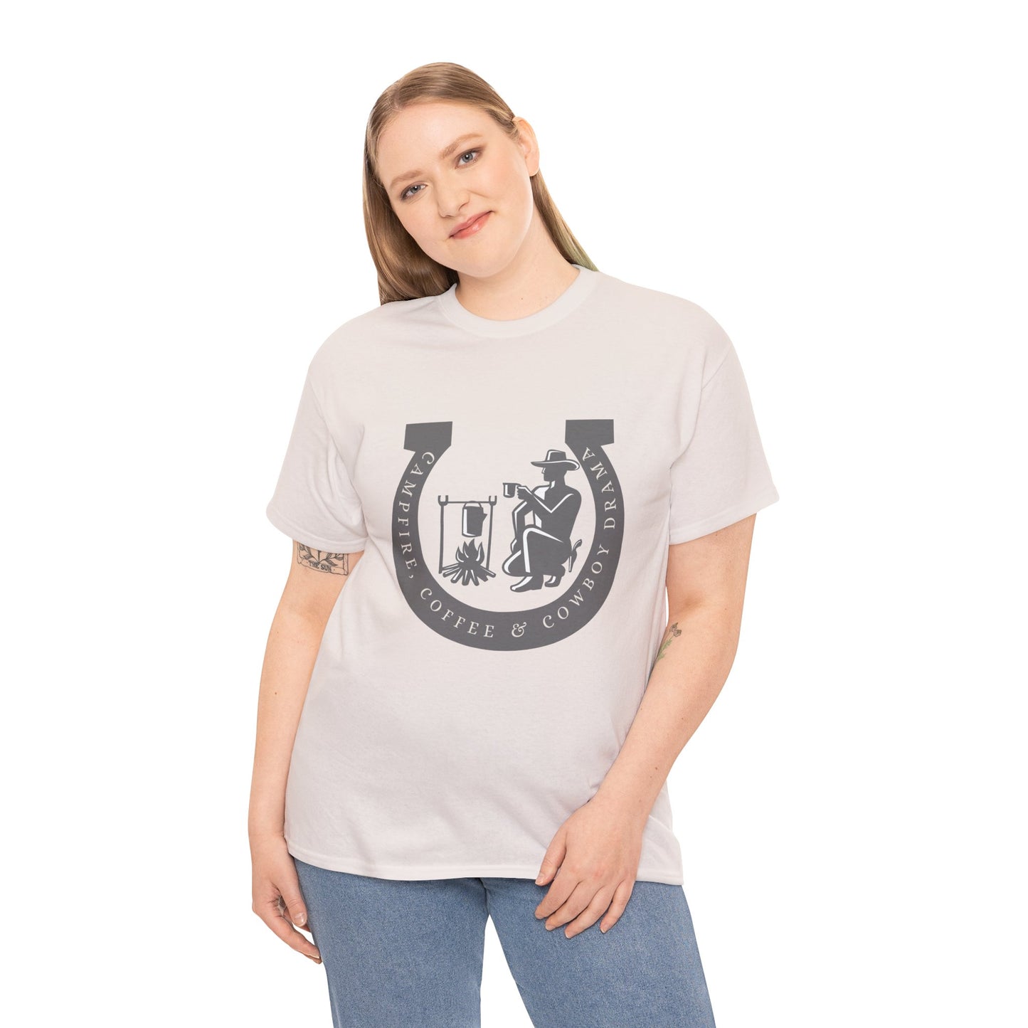 Woman wearing an ice gray t-shirt with a large gray horseshoe graphic around a cowboy campfire and text 'Campfire, Coffee & Cowboy Drama'