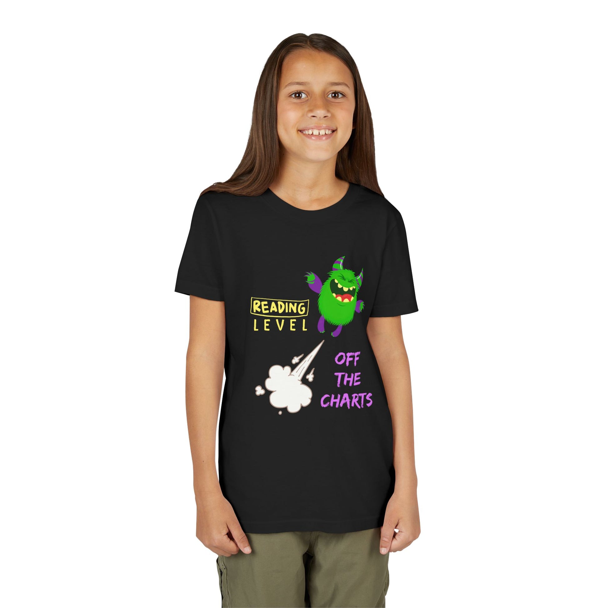 Girl wearing a black t-shirt with a green monster blasting off and text 'Reading Level Off The Charts'