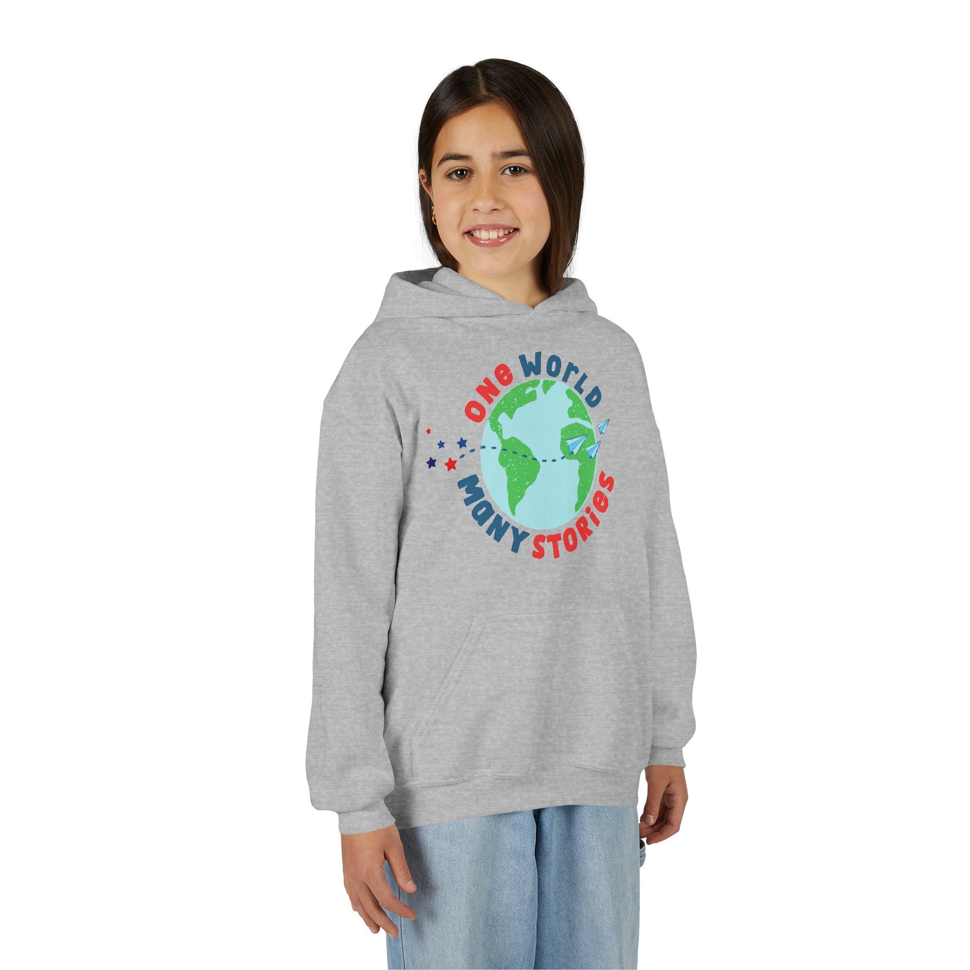Girl wearing a gray hoodie with a graphic of the Earth and 'One World Many Stories' text 