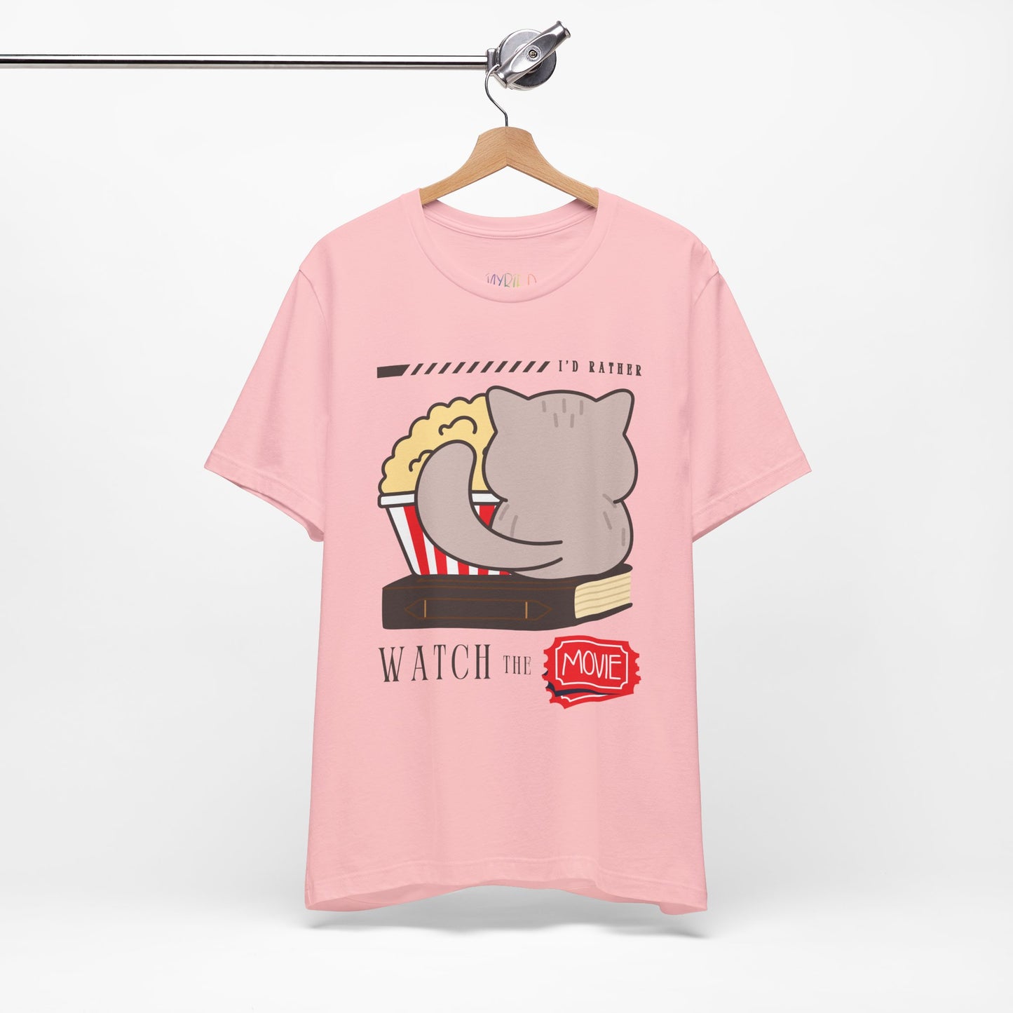 Pink t-shirt with the back of a cat, sitting on a book, with a bucket of popcorn, and text 'I'd Rather Watch The Movie' 