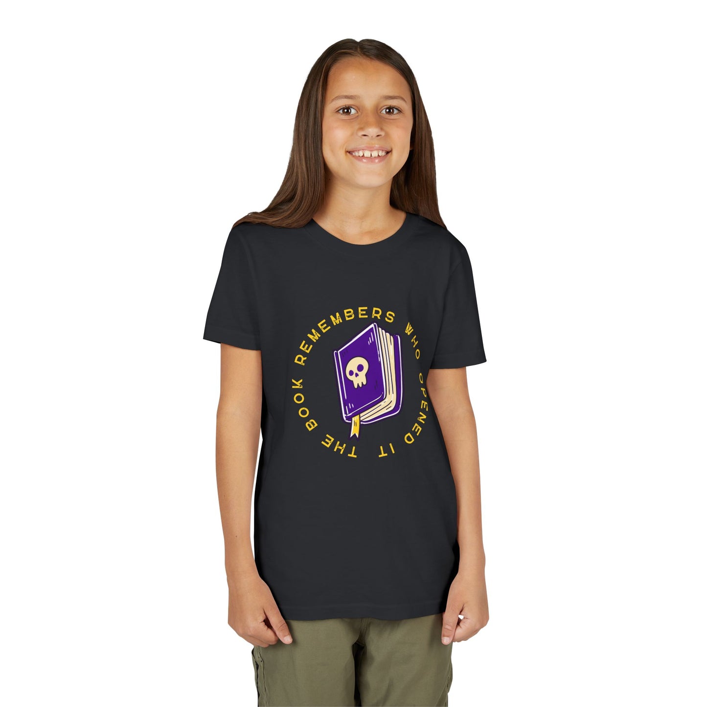 Girl wearing a black t-shirt with a purple book graphic, featuring a skull on the cover and surrounded by yellow text 'The Book Remembers Who Opened It'