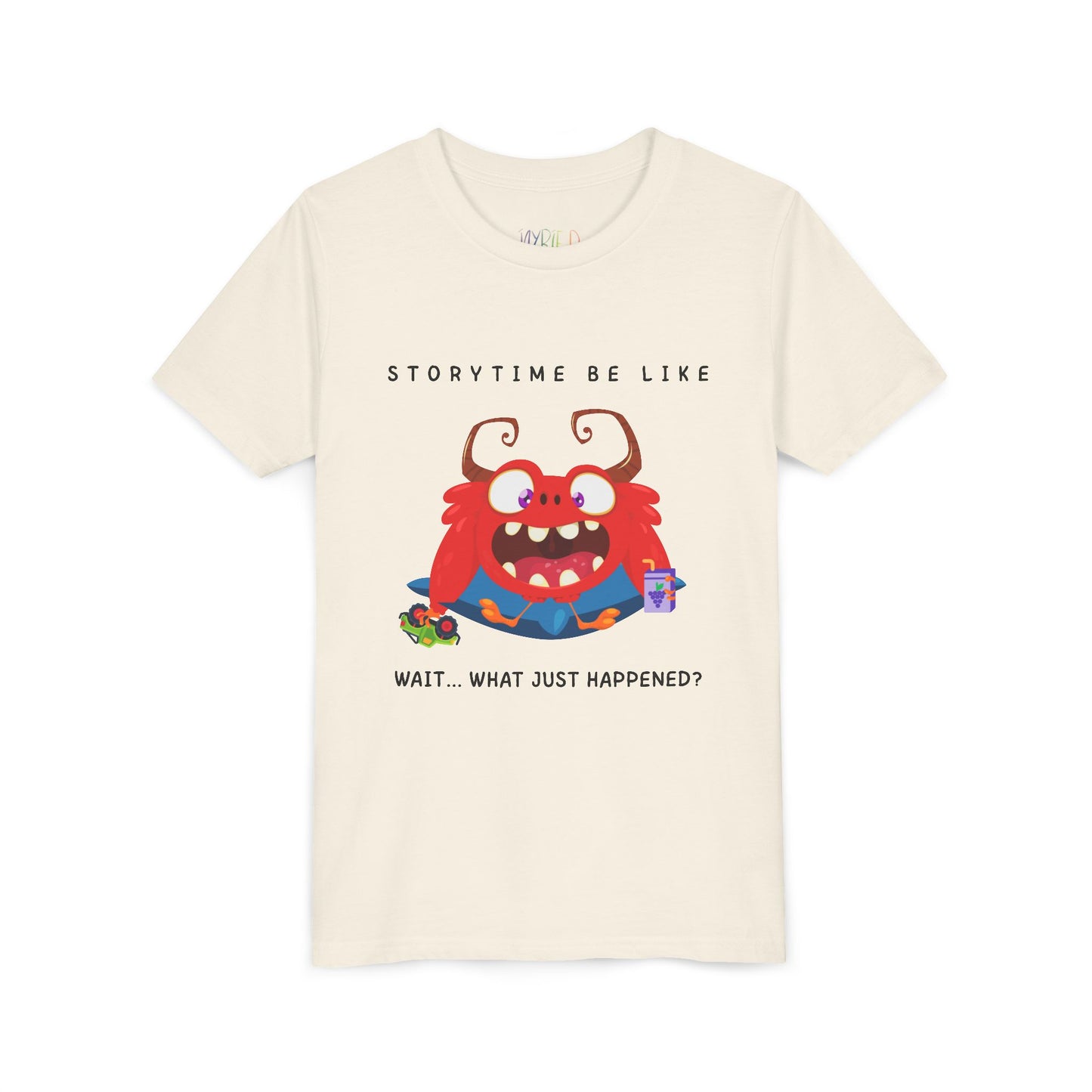Beige t-shirt with a bewildered cartoon monster graphic sitting on a pillow, holding a car toy and a juice box, text 'Storytime be like wait...what just happened?'