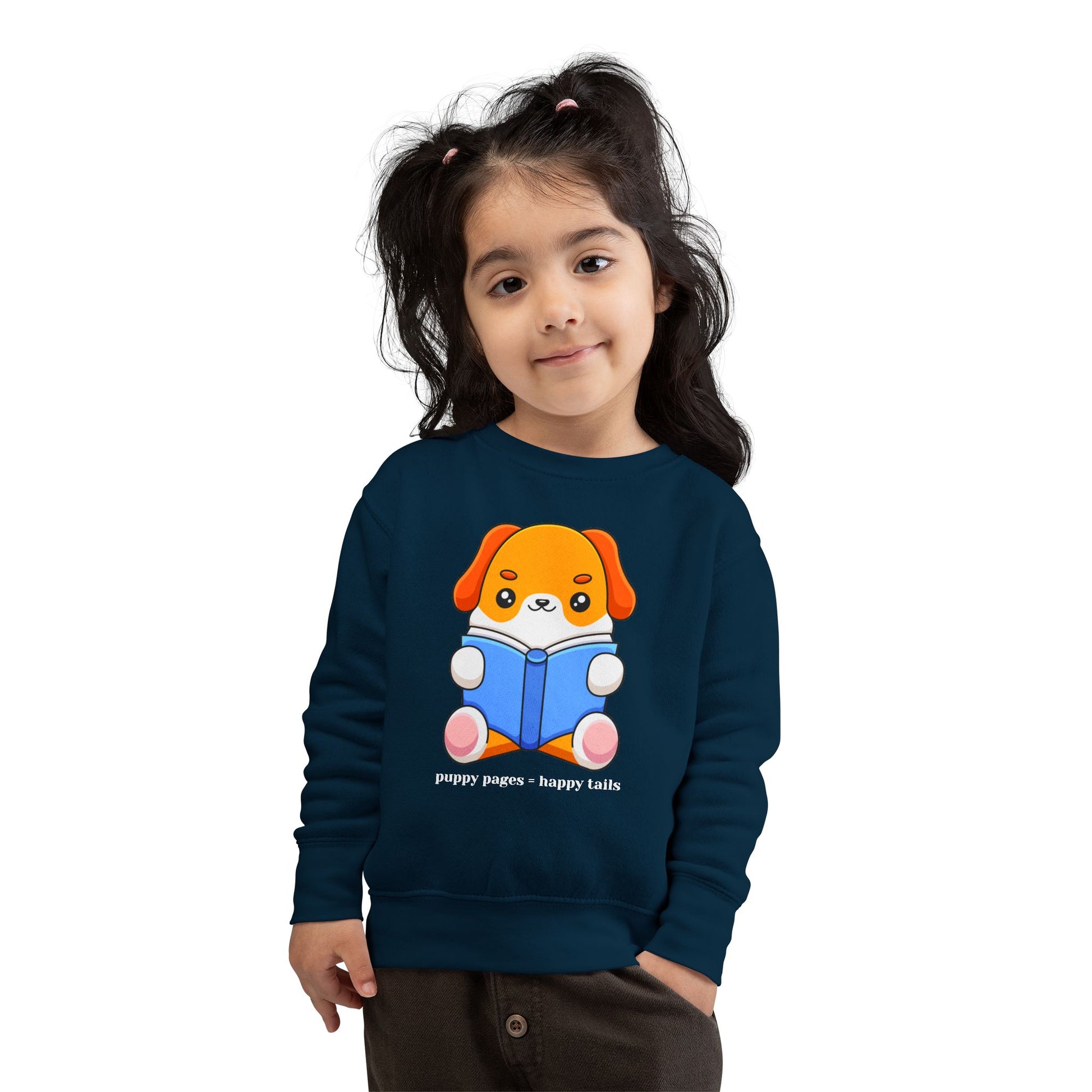 Girl wearing a navy blue toddler sweatshirt with a cartoon dog reading a book and text 'puppy pages - happy tails'