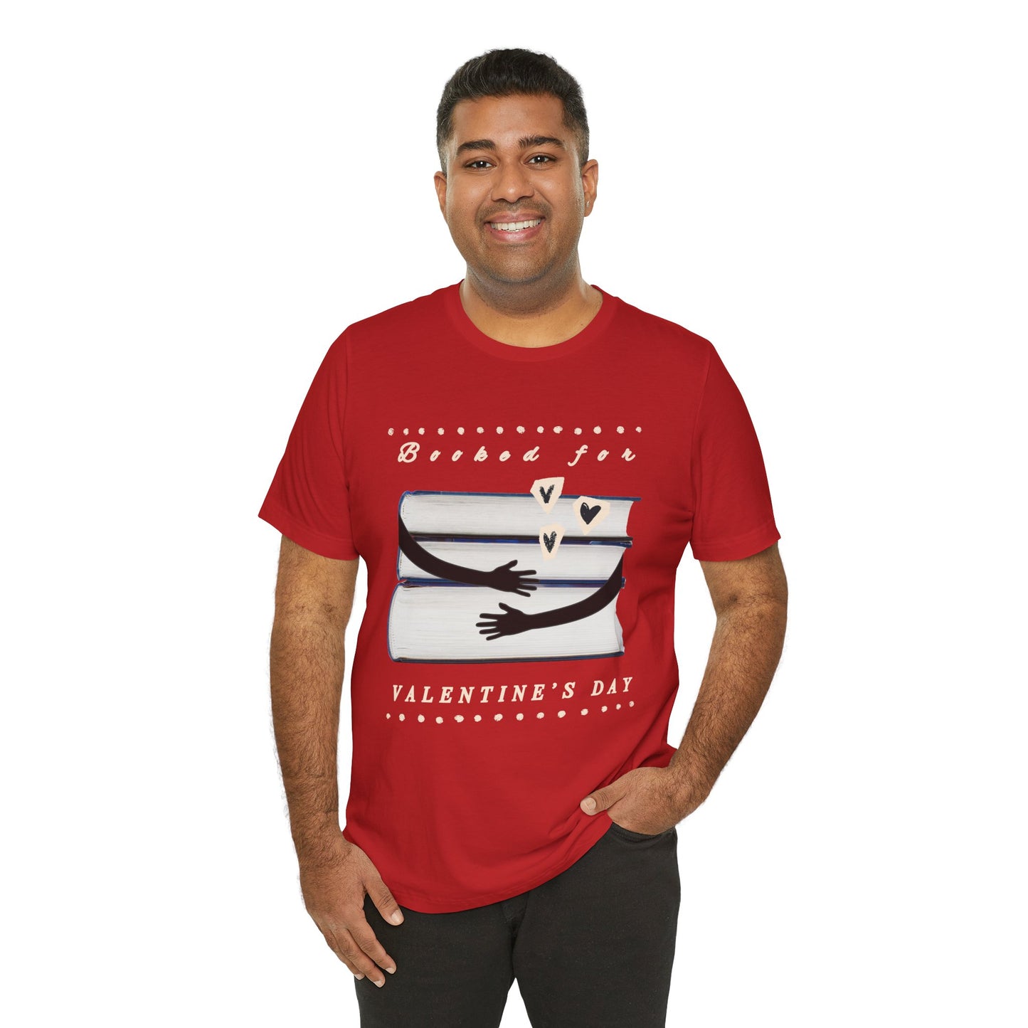 Man wearing a red t-shirt with a graphic design featuring arms hugging a stack of books and text 'Booked for Valentine's Day' 