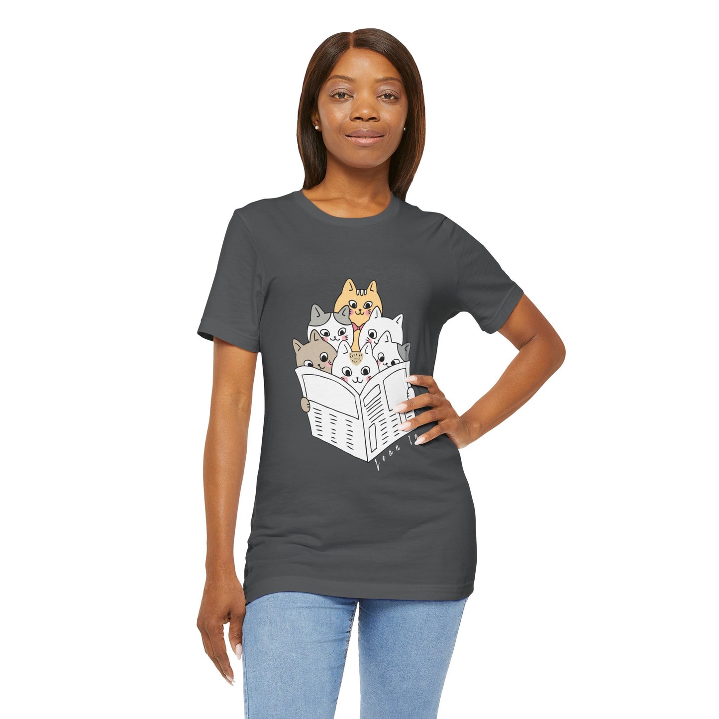 Woman wearing a gray t-shirt with cartoon cats squeezed in to read the newspaper and text 'Lean In'