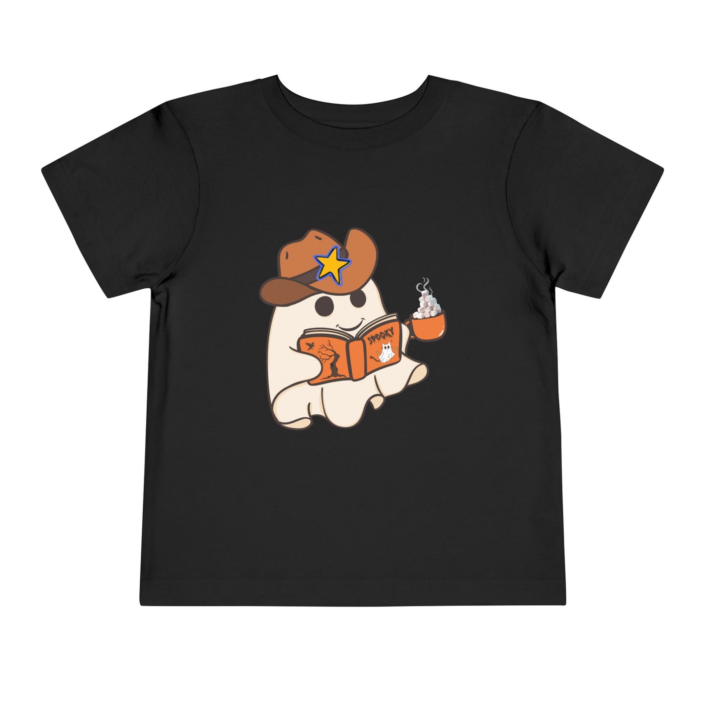 Black toddler t-shirt with a cartoon ghost, wearing a cowboy hat, reading a spooky book and holding a cup of hot cocoa