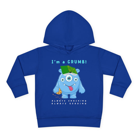 Blue cartoon monster holding a cookie and a book with the words “I’m a Crumb” above — printed on a soft toddler hoodie.