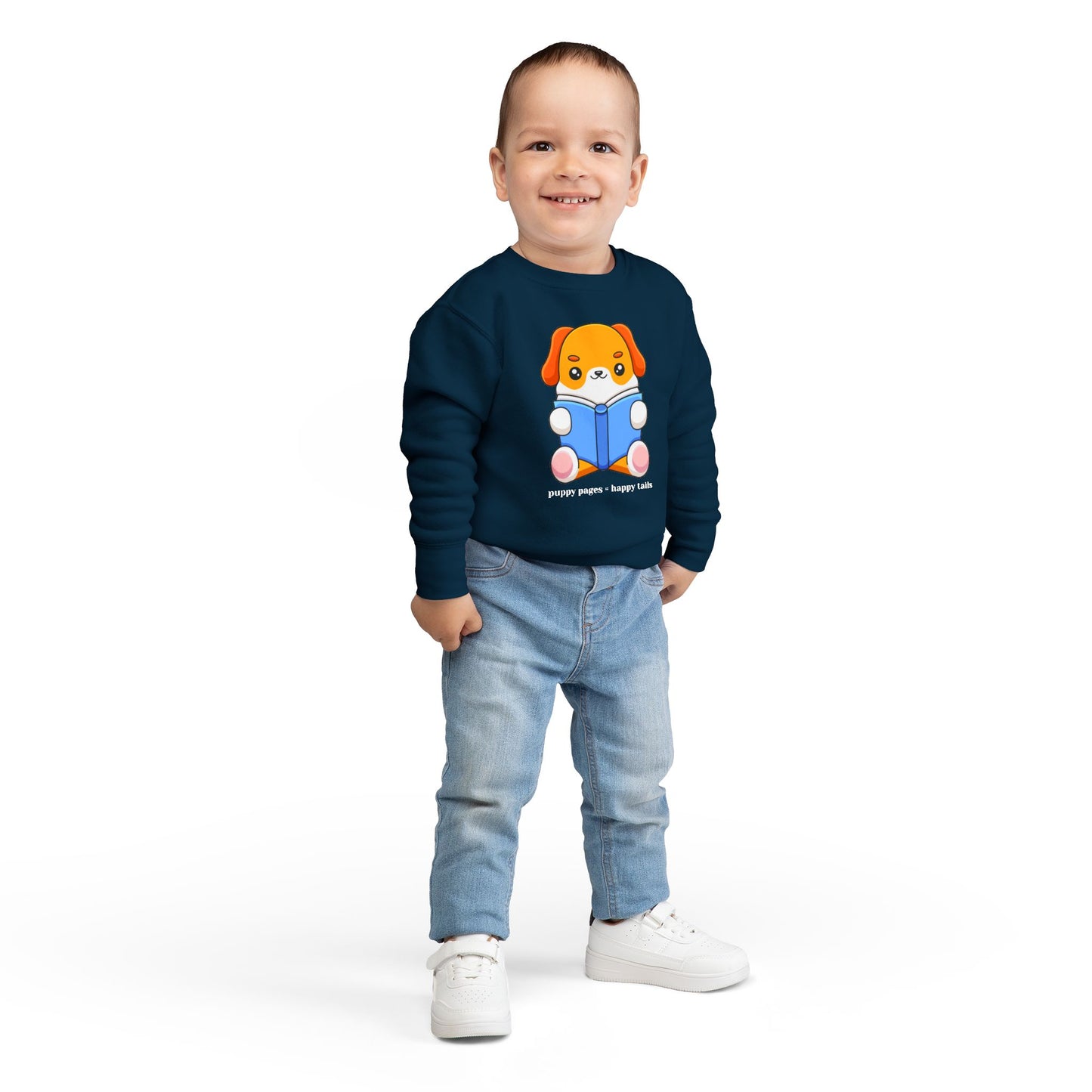 Boy wearing a navy blue toddler sweatshirt with a cartoon dog reading a book and text 'puppy pages - happy tails'