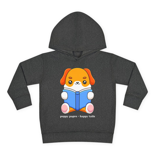 Cute cartoon puppy with orange ears and white fur sitting upright and reading a blue book — printed on a dark toddler hoodie.