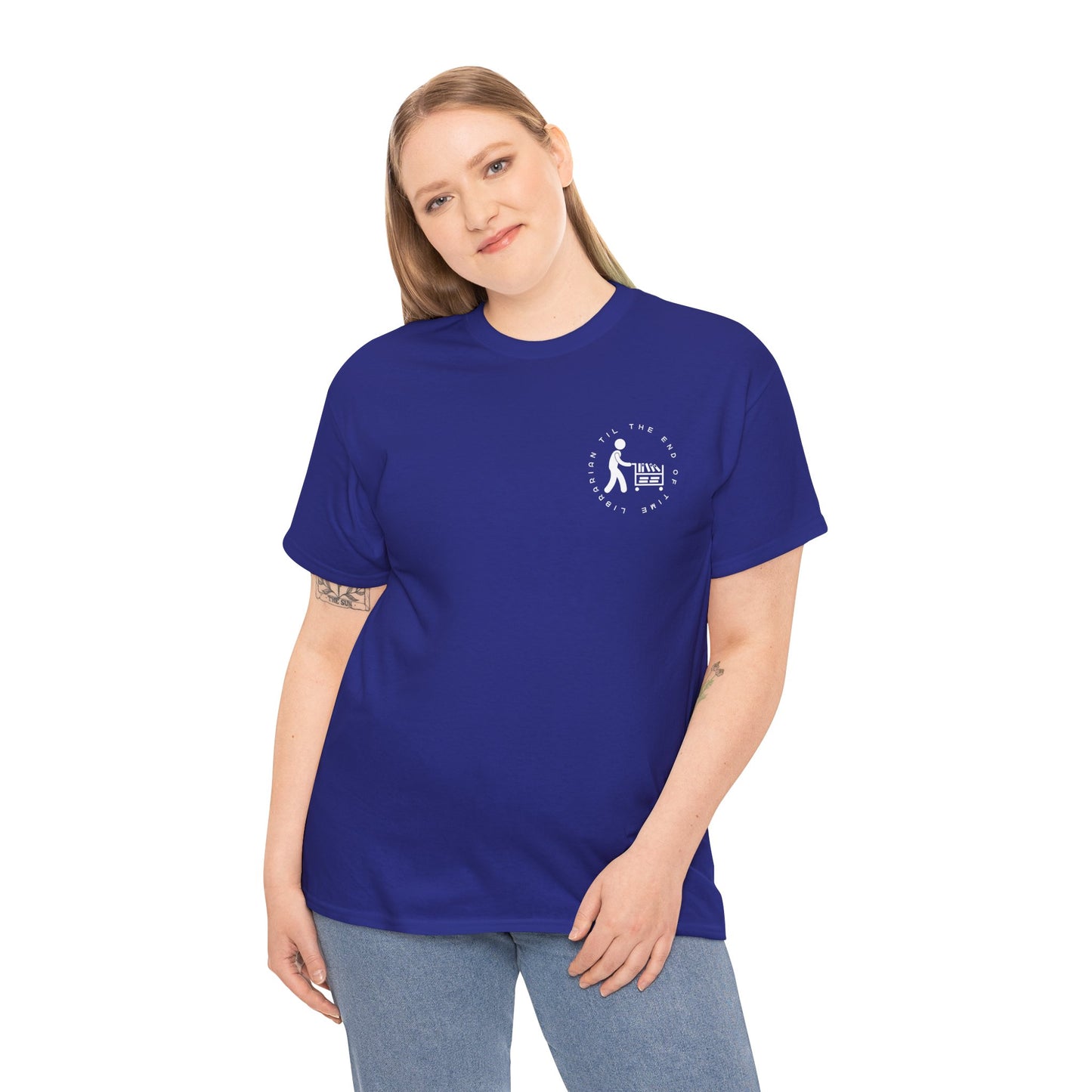 Woman wearing a blue dual-sided t-shirt with a small librarian pushing a cart on the front and a full size bookshelf with a zombie hand reaching up on the back, text 'Late Fees Can't Stop Me'