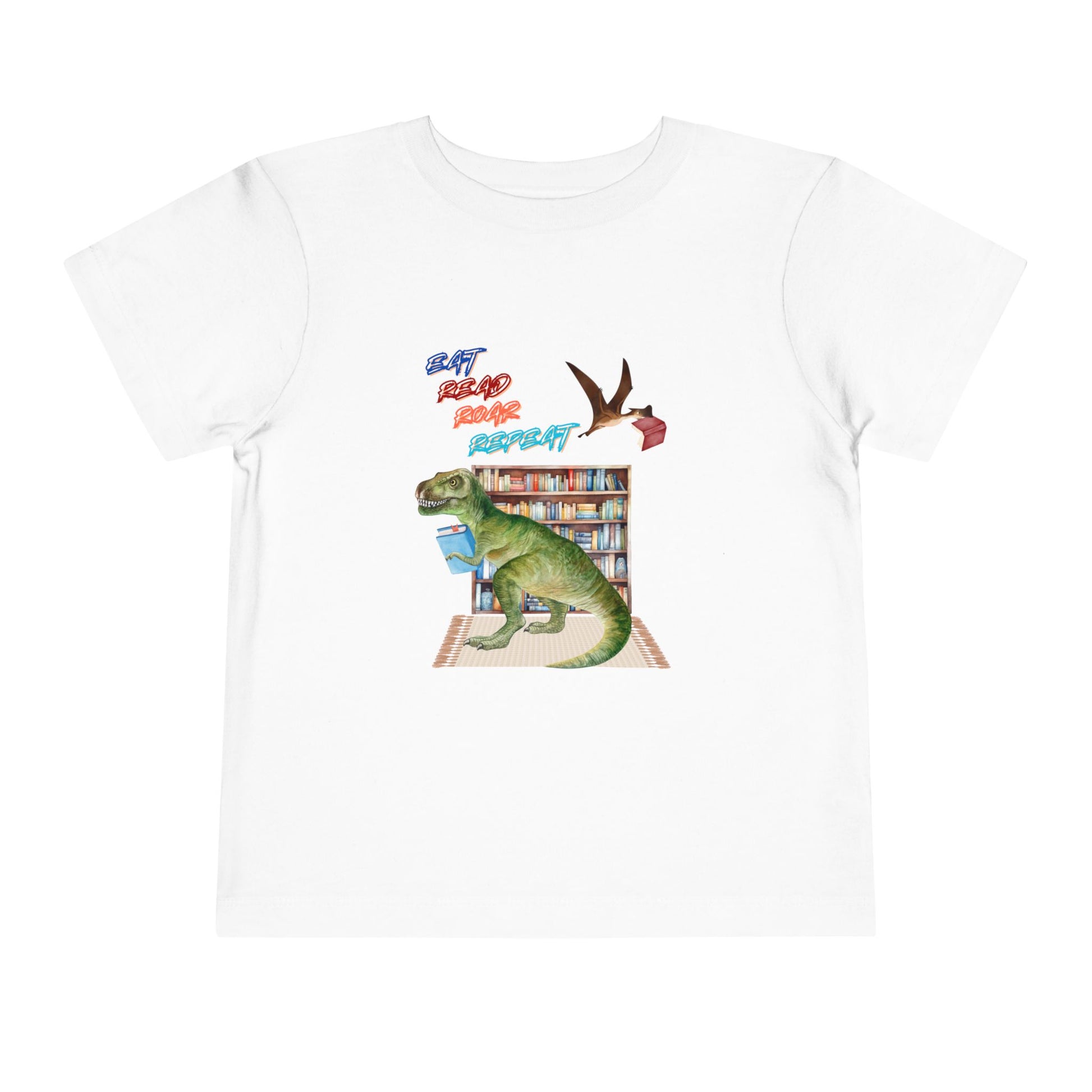 White toddler t-shirt with a t-rex dinosaur checking out a book at the library, a tera dactyl flying overhead with a book and text 'Eat, Read, Roar, Repeat' 