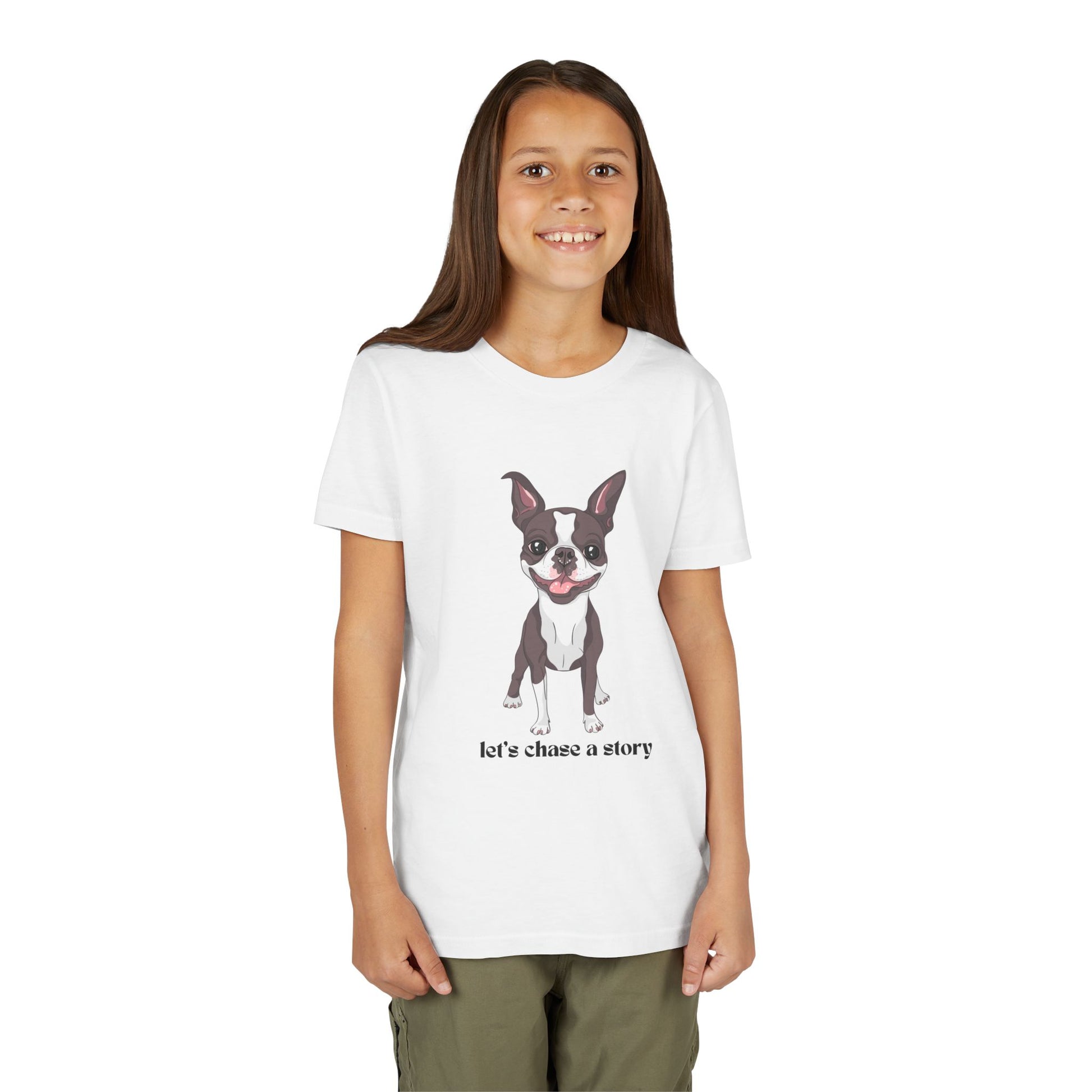 Girl wearing a white t-shirt with a cut dog and text 'let's chase a story'