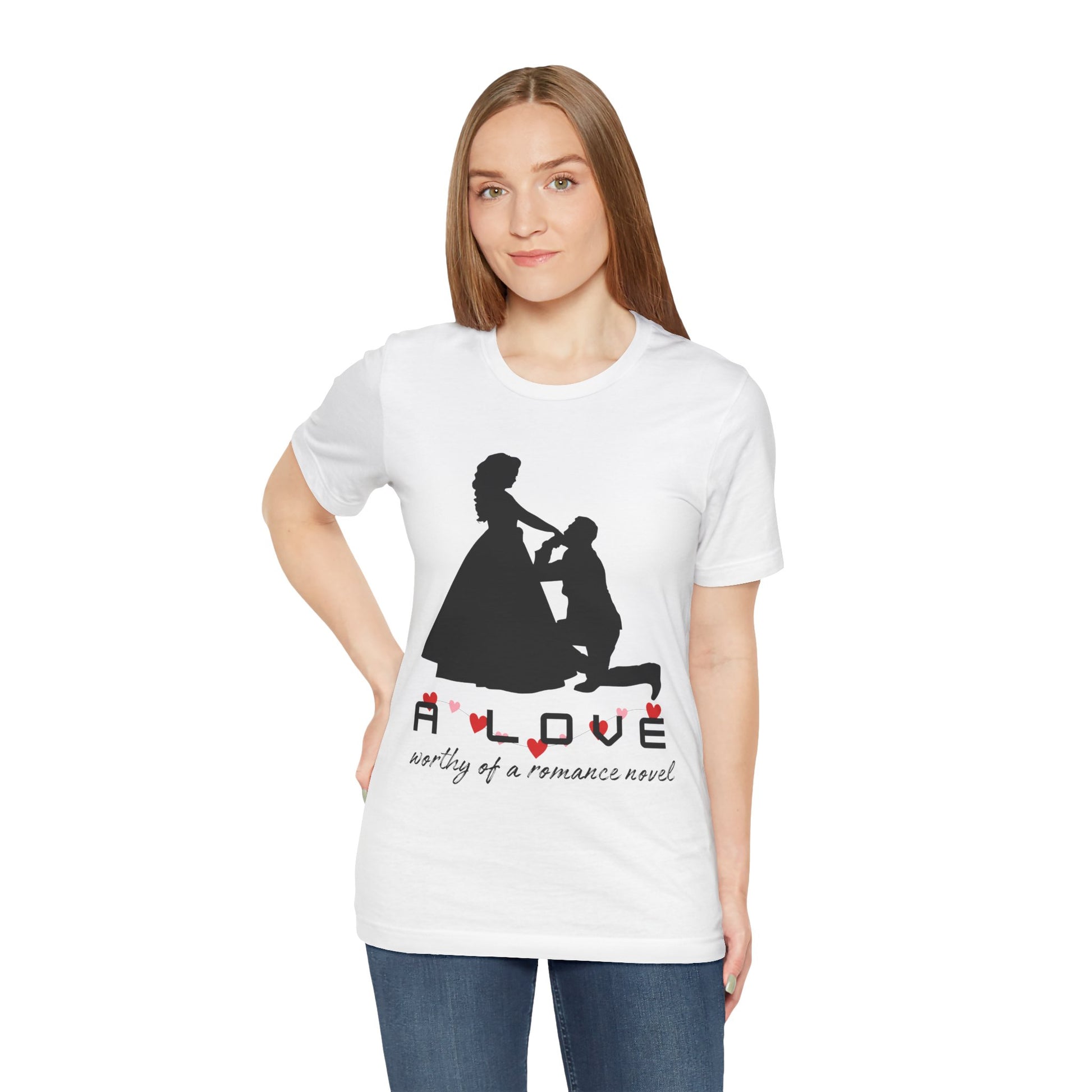 Woman wearing a white t-shirt with black graphic if a man kneeling in front of a woman in a gown and text 'A LOVE worthy of a romance novel'
