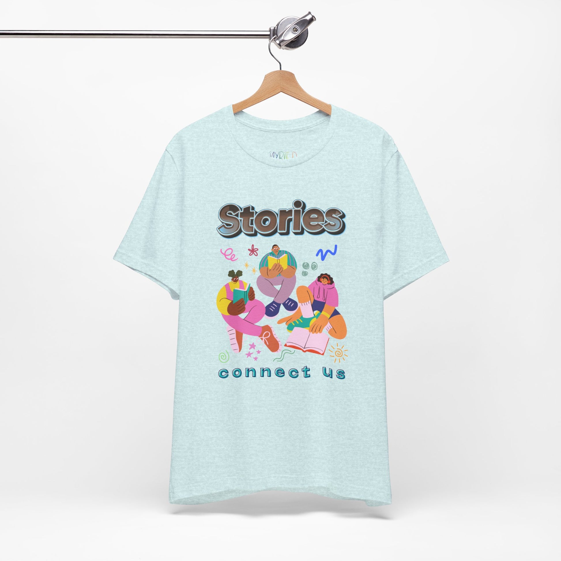 Light ice blue t-shirt with colorful modern people reading, surrounded by doodles, and text 'Stories connect us' 