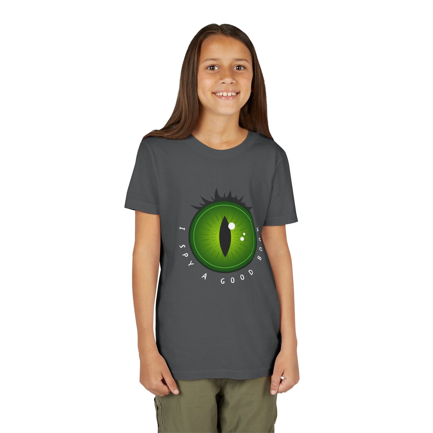 Girl wearing a gray t-shirt with a green monster eye graphic and text 'I SPY A GOOD BOOK'
