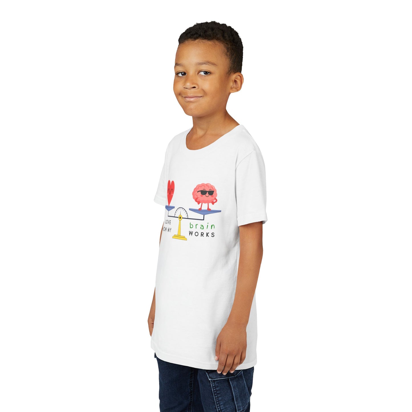 Boy wearing a white t-shirt with a graphic balanced scale design of a heart and brain with text 'I Love How My Brain Works'