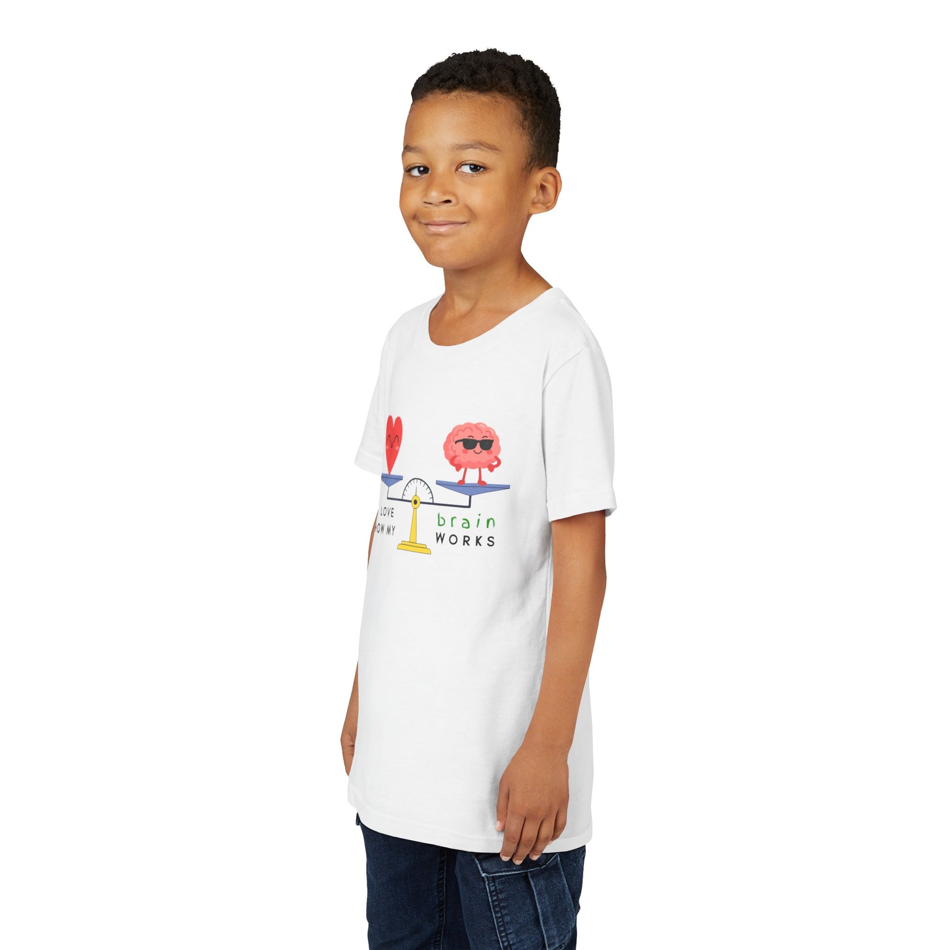 Boy wearing a white t-shirt with a graphic balanced scale design of a heart and brain with text 'I Love How My Brain Works'