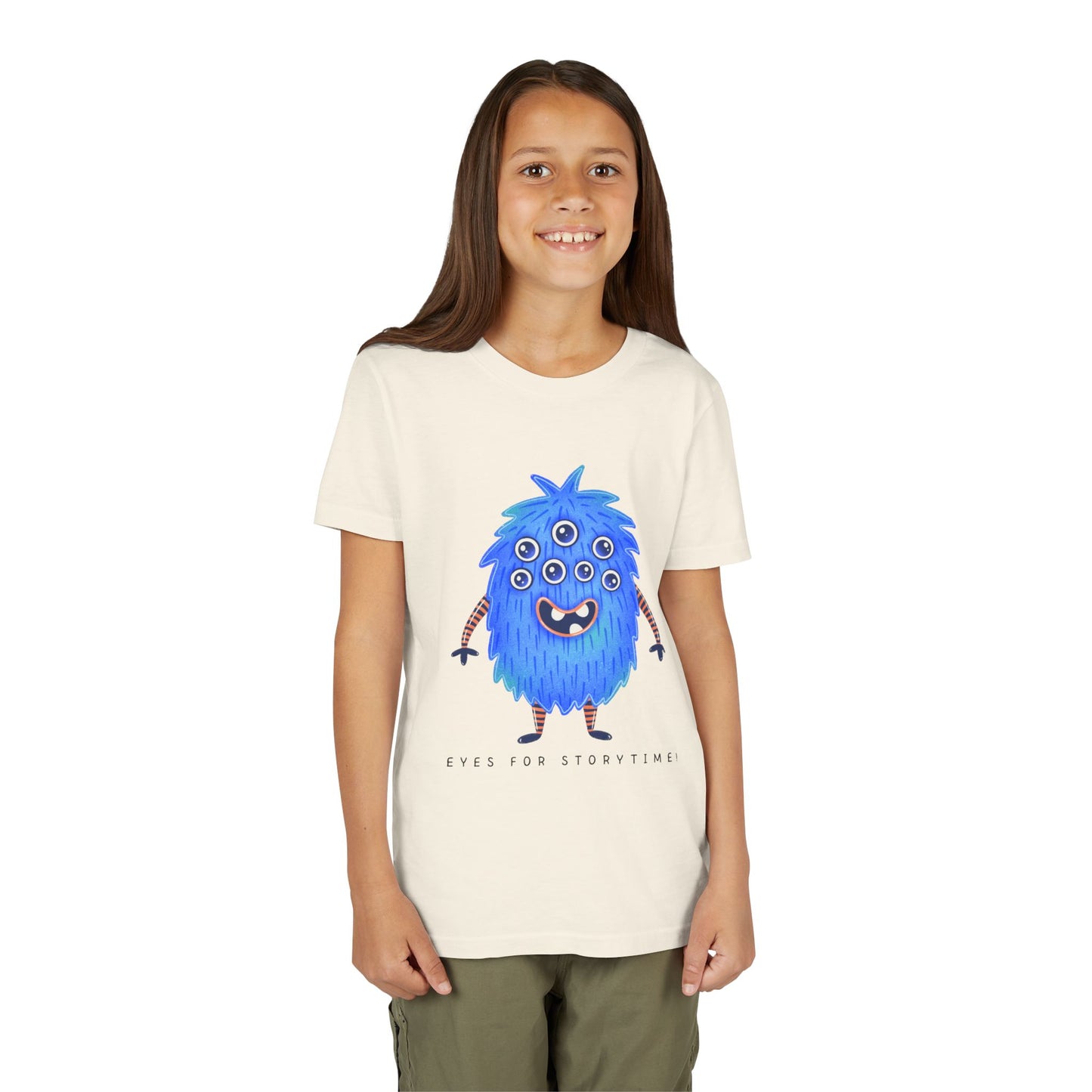 Girl wearing a beige t-shirt with a multi-eyed blue monster graphic and text 'Eyes For Storytime'