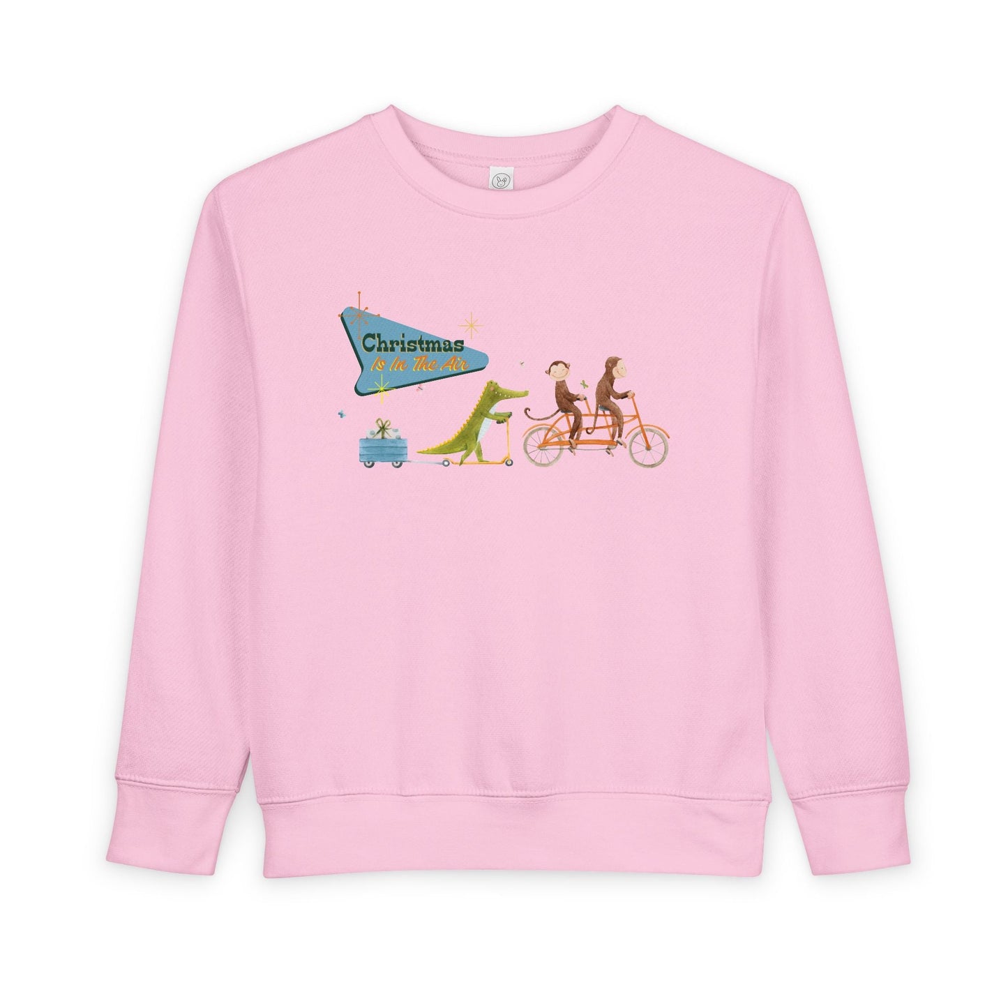Pink toddler sweatshirt with a graphic design of two monkeys riding a tandem bike, followed by a crocodile on a scooter pulling a trailer with a present, text 'Christmas Is In The Air' 
