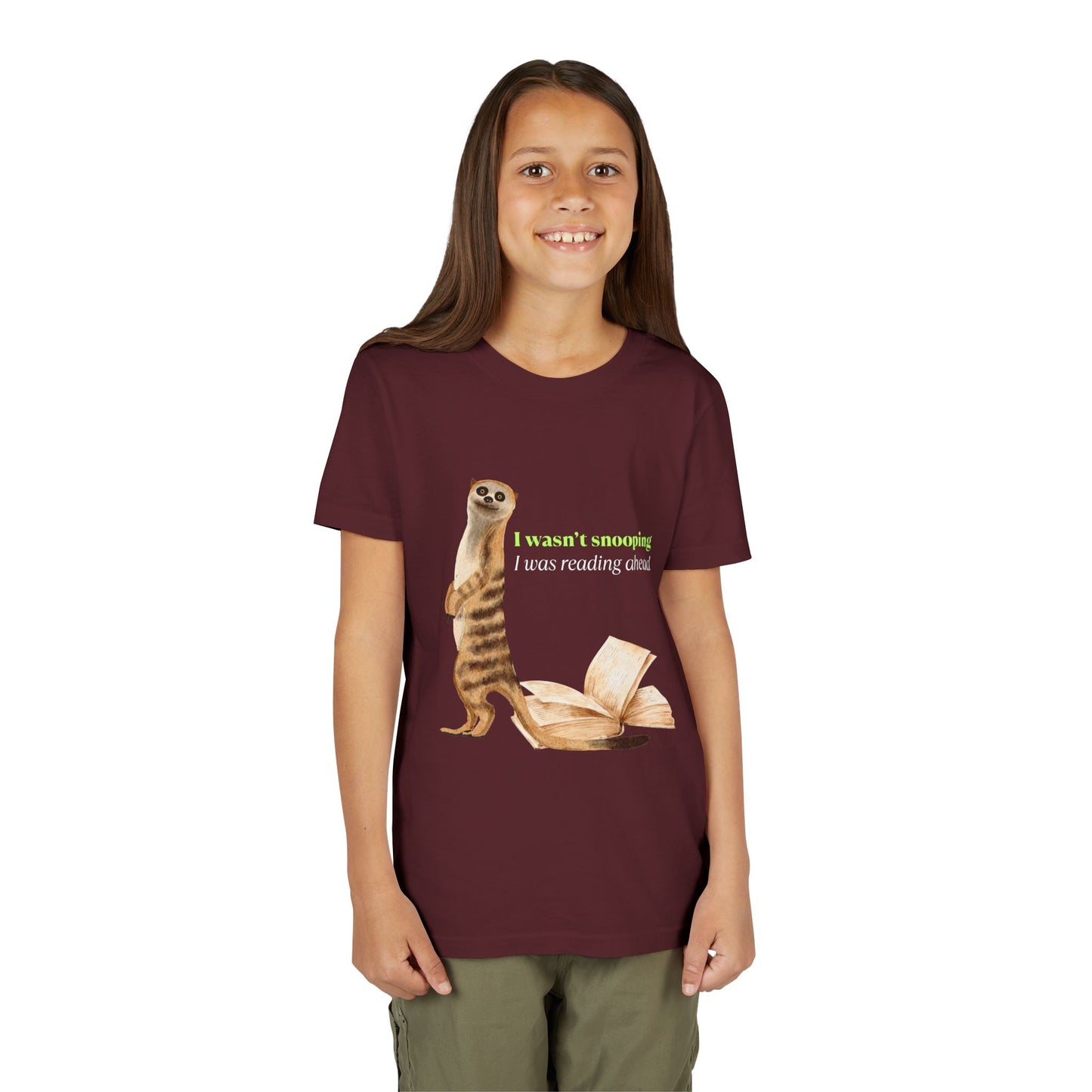 Girl wearing a maroon t-shirt with a guilty looking meerkat and book graphic, text 'I Wasn't Snooping. I Was Reading Ahead.'