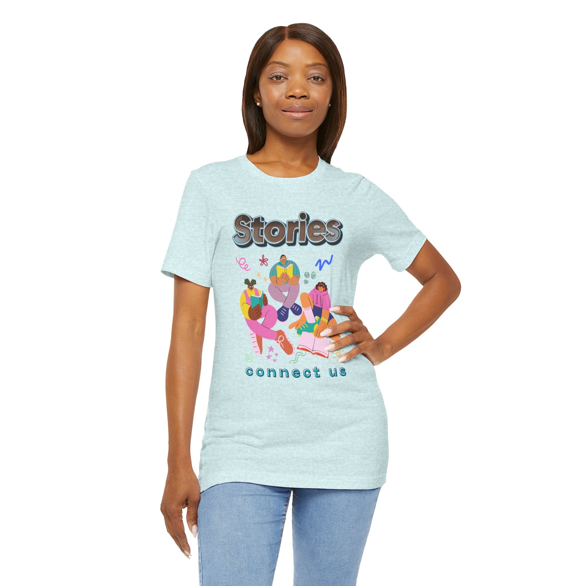 Woman wearing a light ice blue t-shirt with colorful modern people reading, surrounded by doodles, and text 'Stories connect us' 