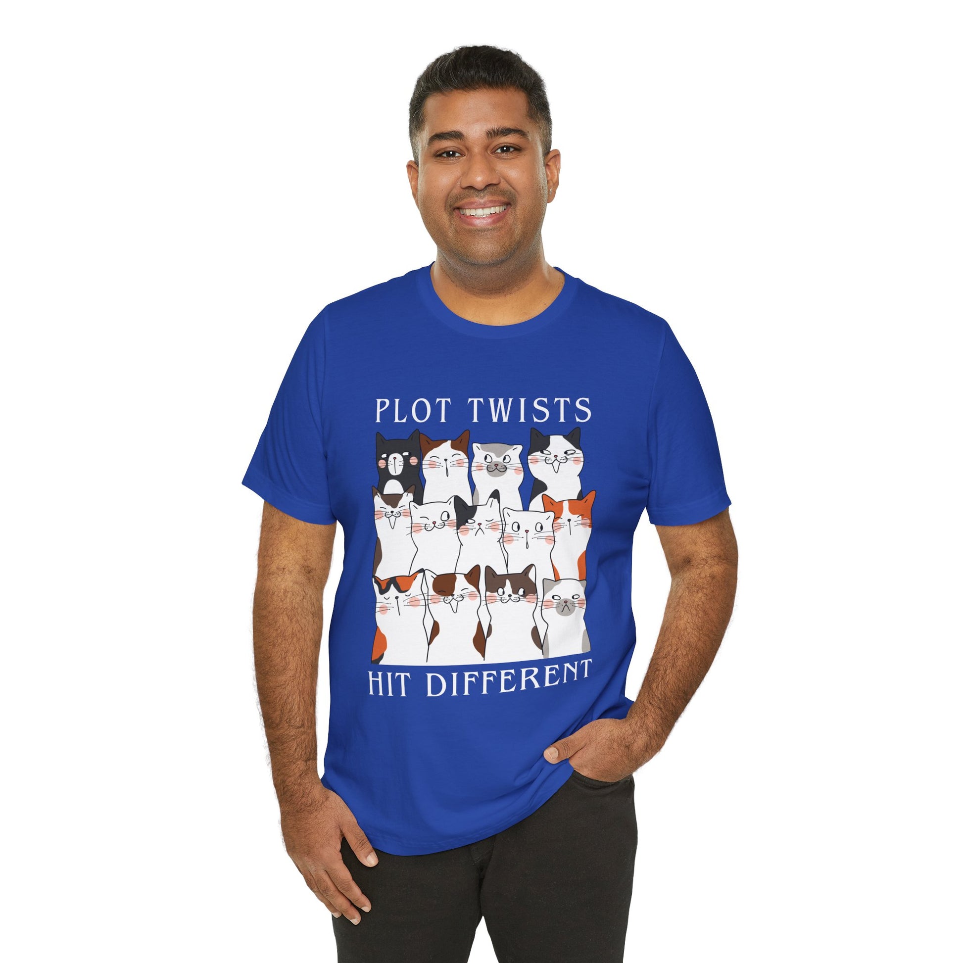 Man wearing a blue t-shirt with rows of cats making different faces and text 'Plot Twists Hit Different' 
