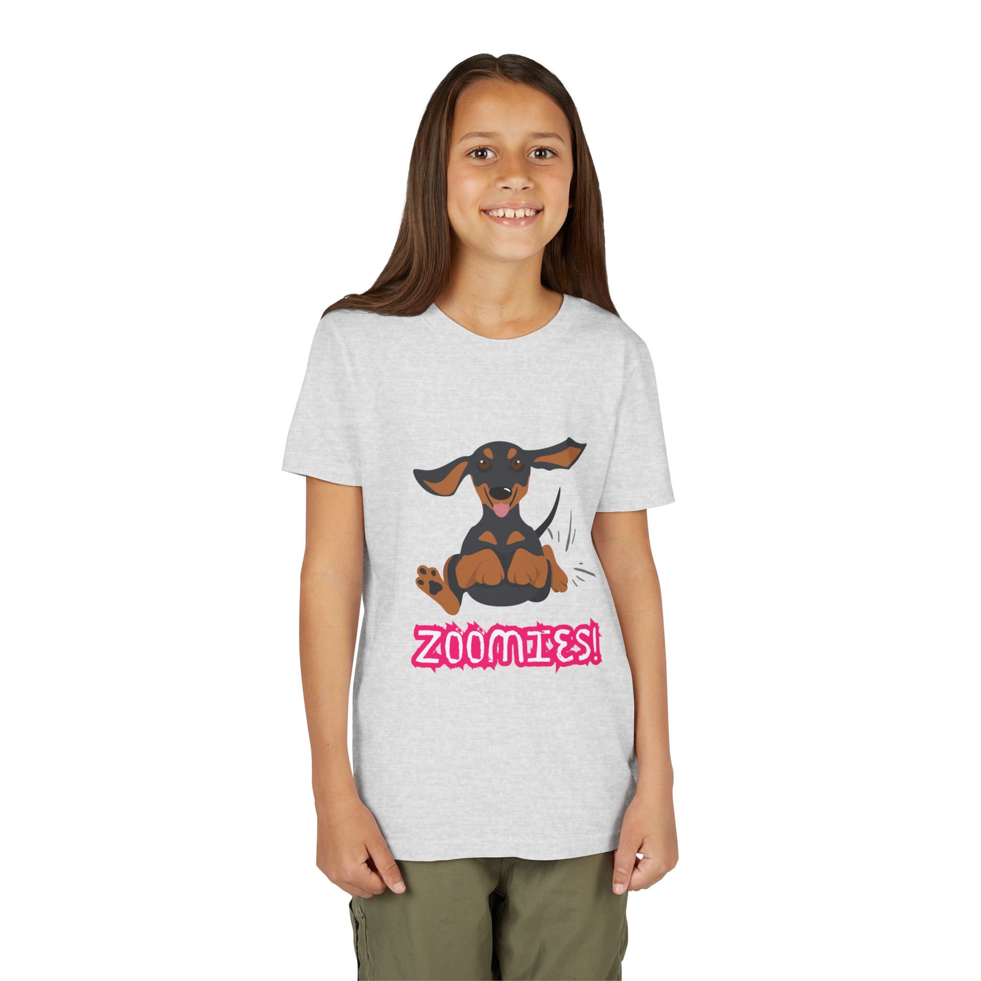 Girl wearing a light gray t-shirt with a running dachshund and 'Zoomies!' text 