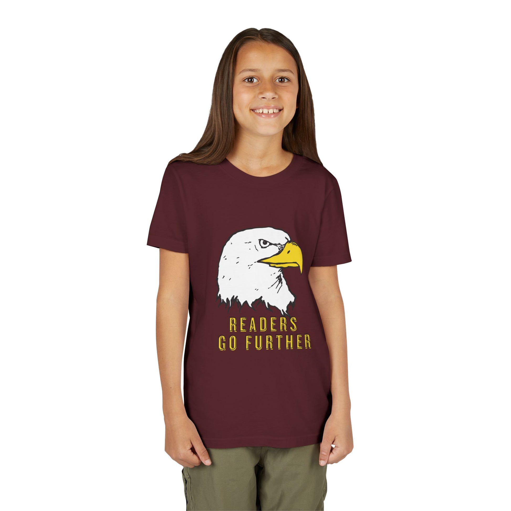 Girl wearing a marron t-shirt with an eagle graphic and 'Readers Go Further' text