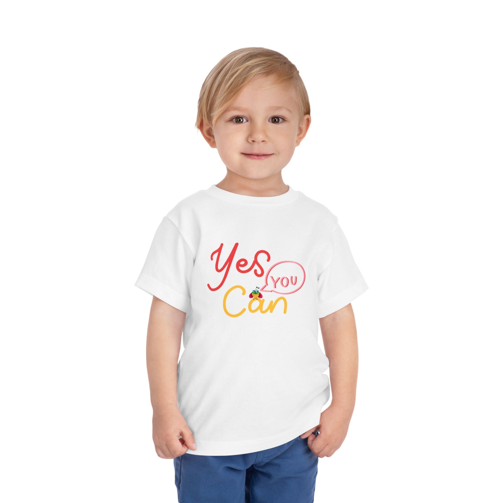 Toddler wearing a white t-shirt with 'Yes You Can' text design
