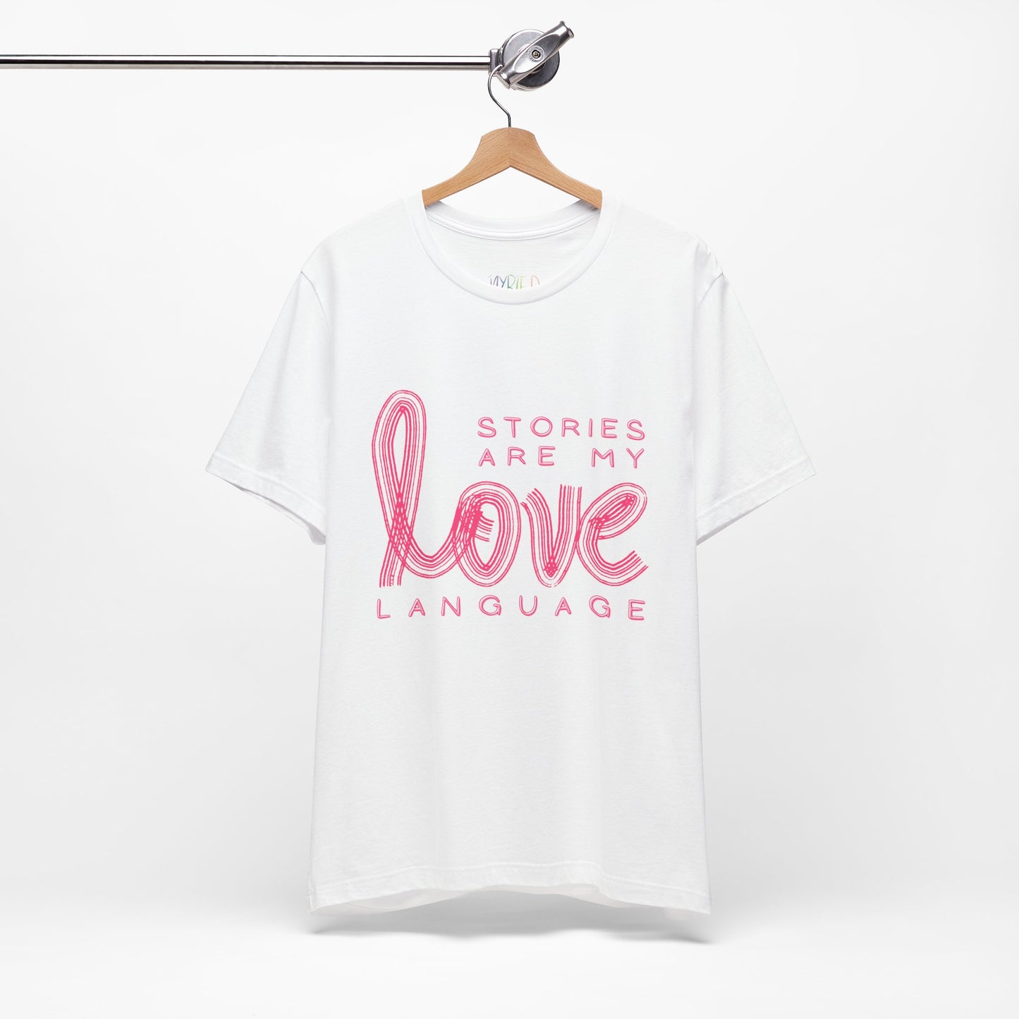 White t-shirt with pink text 'Stories Are My Love Language'