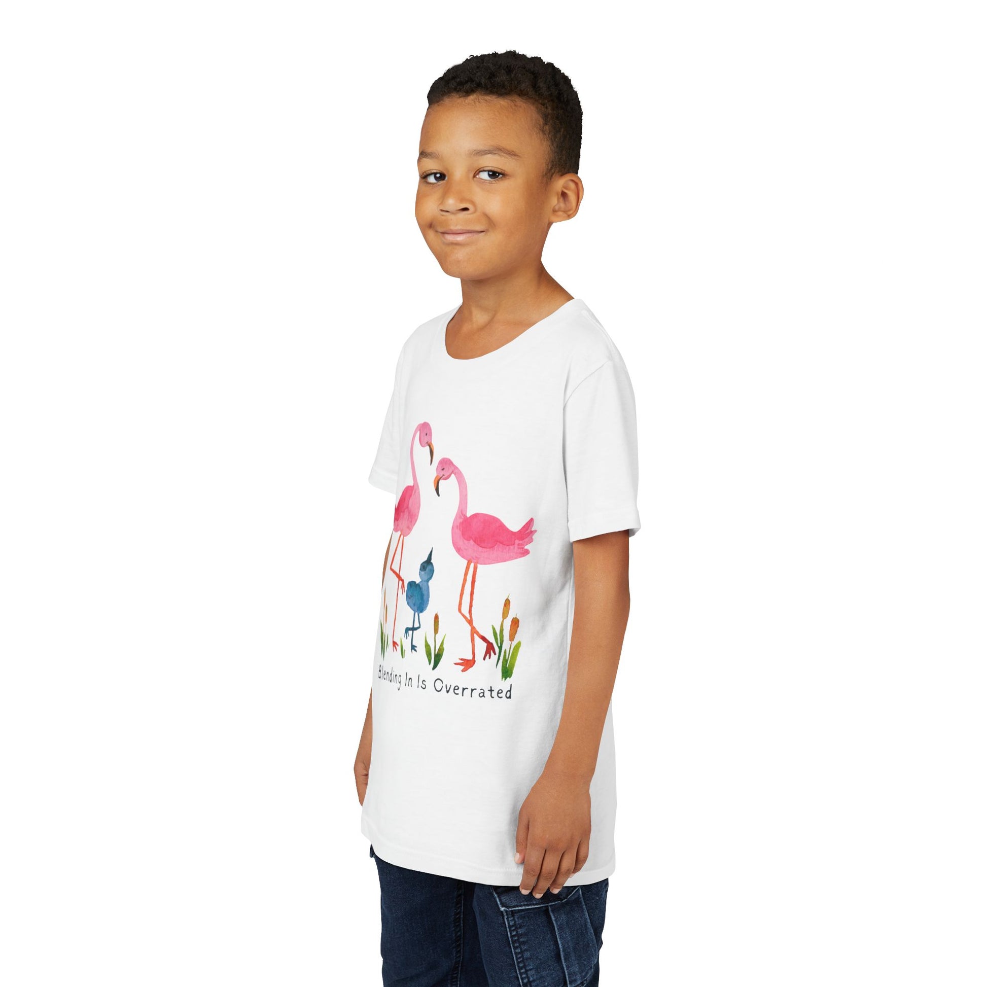 Boy wearing a white t-shirt with a flamingo family and text 'Blending In Is Overrated' 