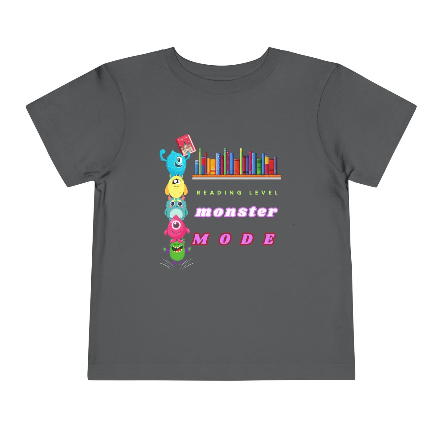 Gray toddler t-shirt with colorful monsters stacked on top of each other to reach a book from a bookshelf and text 'Reading Level Monster Mode'