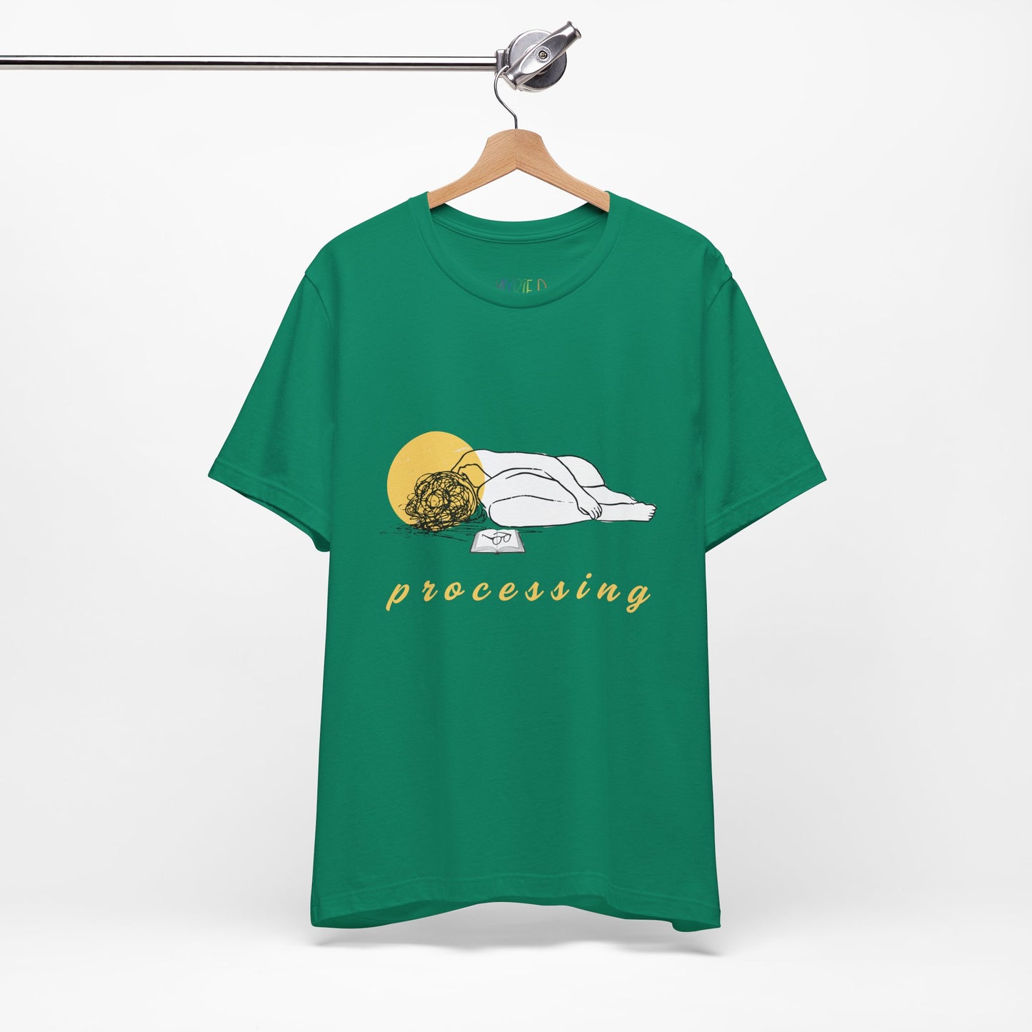Green t-shirt with person laying in a heap next to a book and 'processing' text 