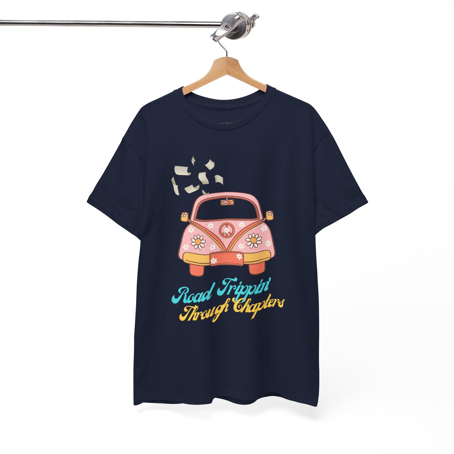 Navy blue t-shirt with a retro pink car , pages flying out the windows and text 'Road Tripping Through Chapters' 