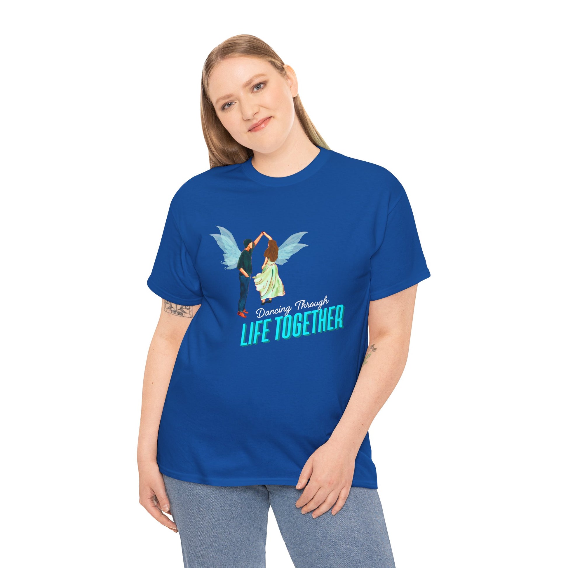 Woman wearing a blue t-shirt with two fairies dancing and text 'Dancing Through Life Together' 