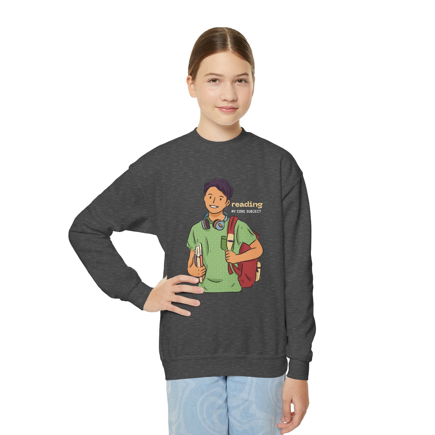 Girl wearing a dark gray sweatshirt with a graphic of a person holding books, carrying a backpack and text 'Reading: My Core Subject'