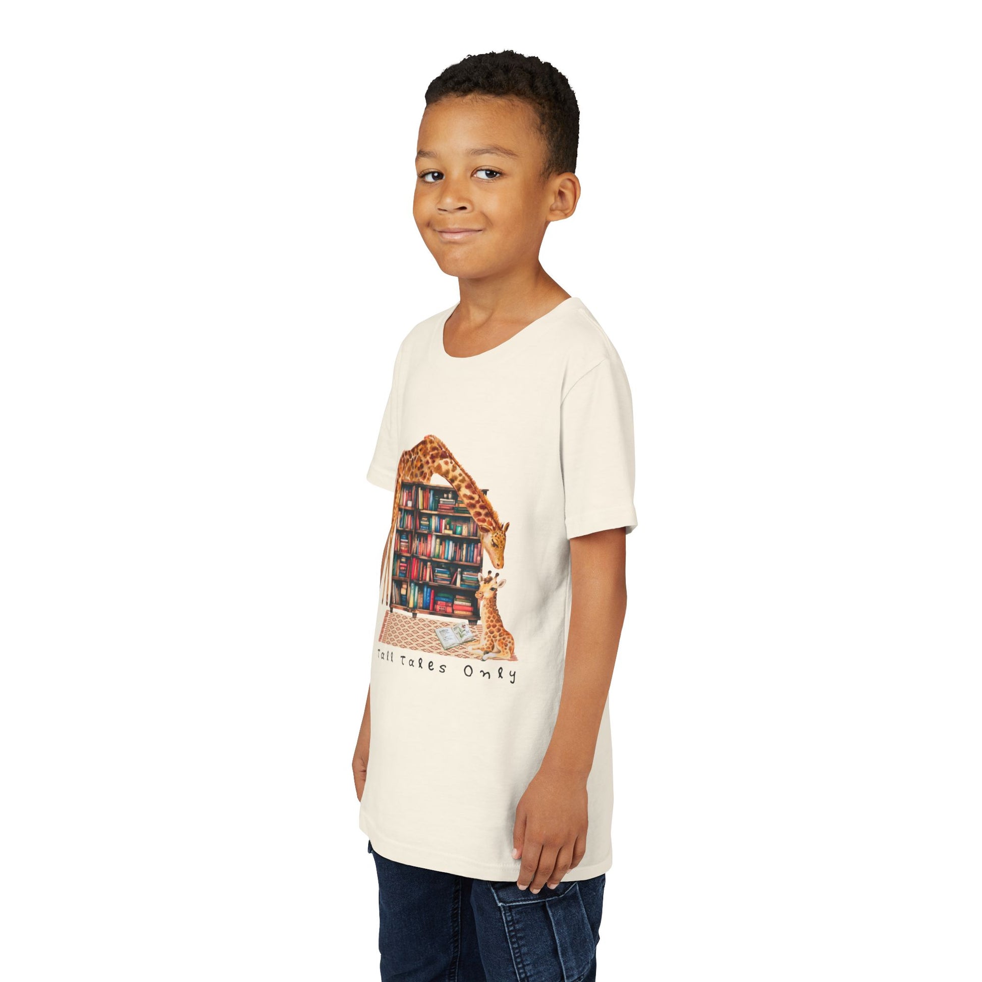 Boy wearing a beige t-shirt with a graphic of giraffes in a library and 'Talk Tales Only' text 