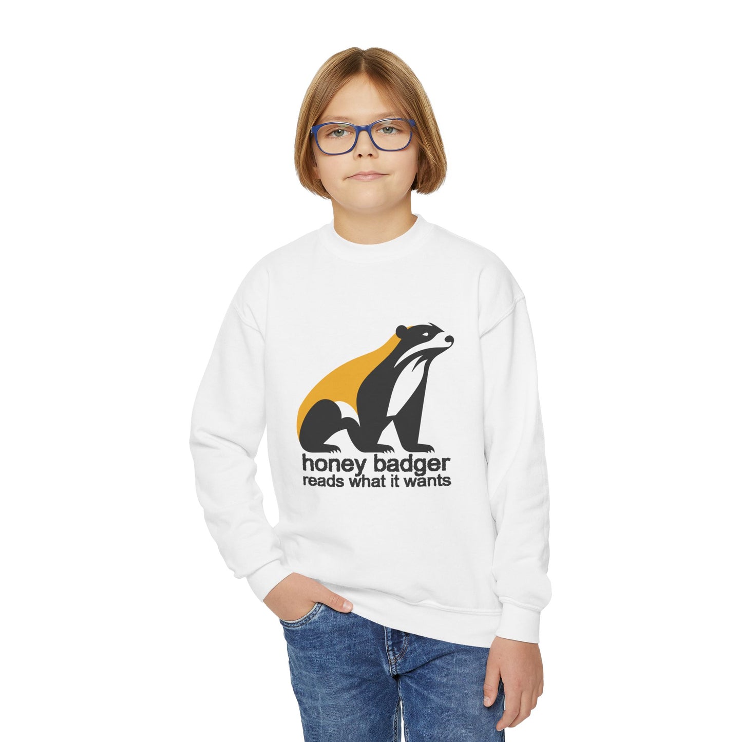 Boy wearing a white sweatshirt with honey badger graphic and text 'honey badger reads what it wants'