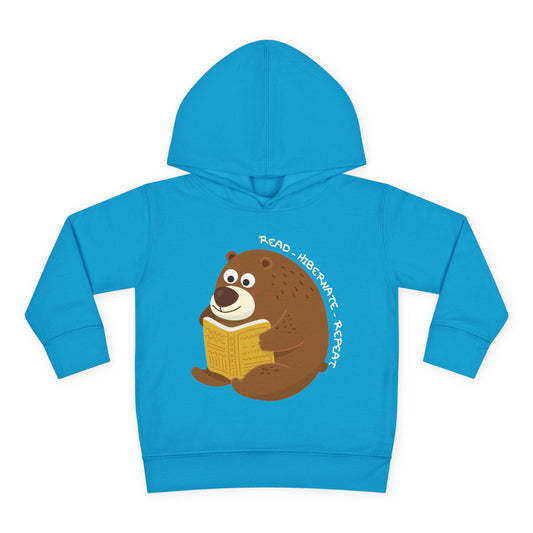 Blue hoodie with a bear reading a book graphic and the words 'Read - Hibernate - Repeat'